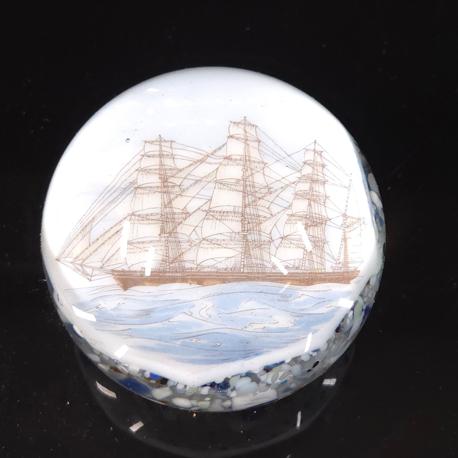 1930'S ART GLASS PAPERWEIGHT W/ SAILING SHIP: REMAINS IN GOOD CONDITION. NO CHIPS OR CRACKS. 3 INCHES ROUND.