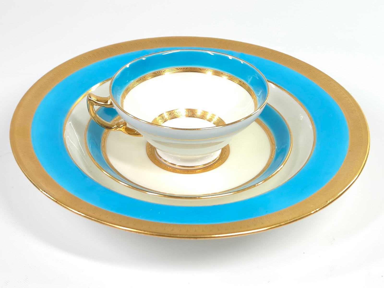 MINTON TIFFANY & CO GOLD & BLUE CUP SAUCER UNDERPLATE: SET REMAINS IN GOOD CONDITION. CUP HAS SMALL CRACK. SAUCER AND UNDERPLATE REMAIN NICE, NO CHIPS OR CRACKS.
