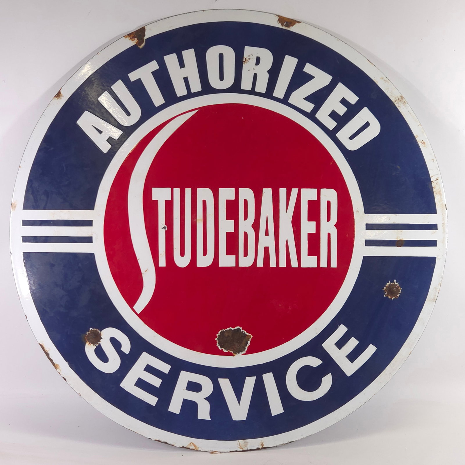 STUDEBAKER PORCELAIN DOUBLE SIDED SIGN: REMAINS IN FAIR TO GOOD CONDITION, SHOWING SOME TYPICAL WEAR. SOME CHIPS TO PORCELAIN AS SHOWN.