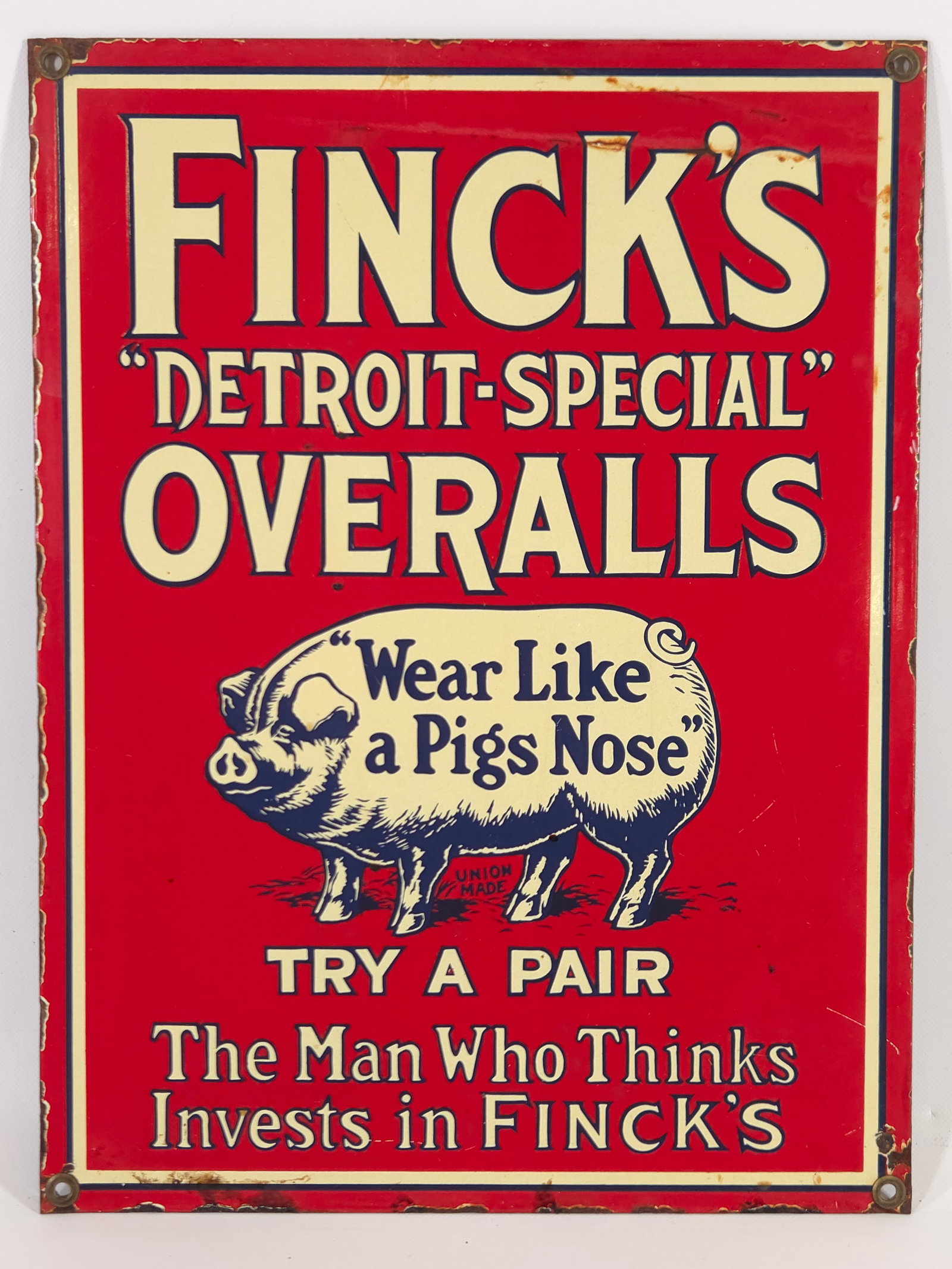 FINKS PIG ADVERTISING OVERALLS PORCELAIN SIGN: REMAINS IN FAIR TO GOOD CONDITION, SHOWING WEAR ALONG THE EDGES.