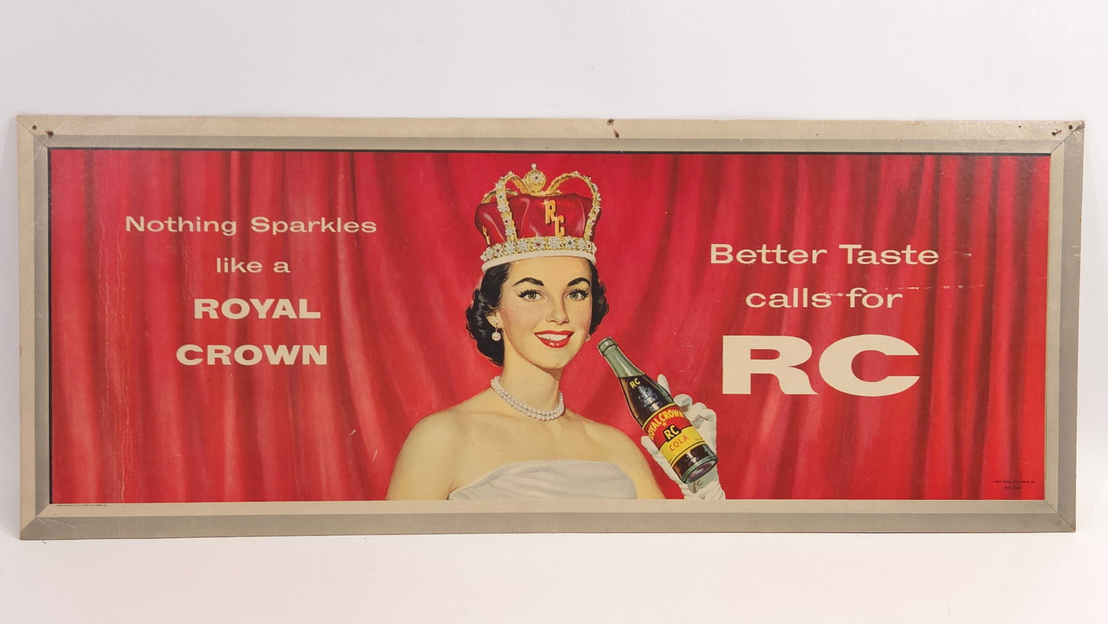 ROYAL CROWN ADVERTISING SODA CARDBOARD SIGN: REMAINS IN GOOD CONDITION, SHOWING SOME TYPICAL WEAR. A FEW STRESS CREASES AND SOME PIN HOLES ALONG TOP EDGE.