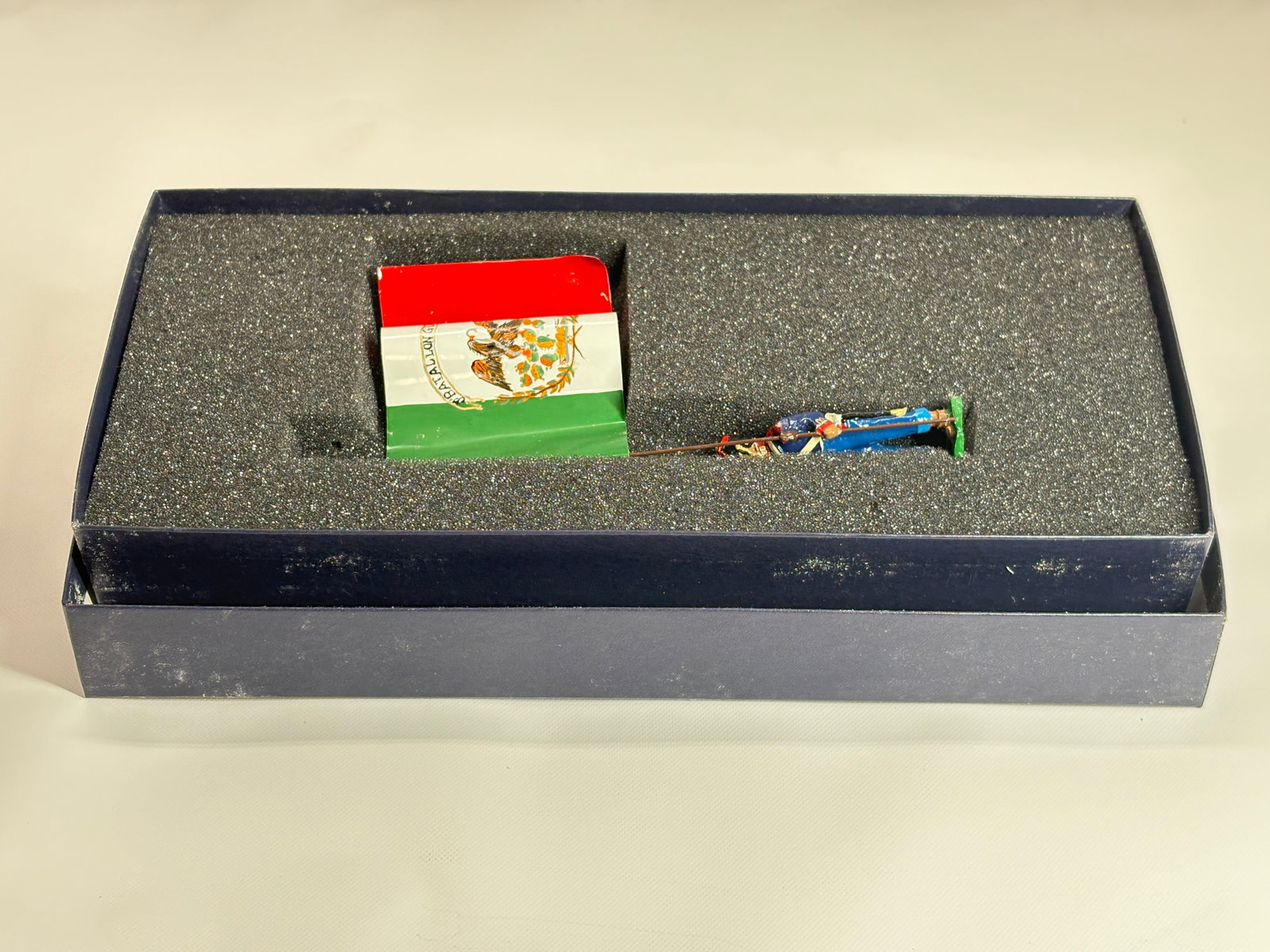 EDMUNDS BATTALION GUERRERO GRENADIER FLAG: REMAINS IN VERY GOOD CONDITION, SHOWING SOME WEAR FROM INSERT, NEED WIPED DOWN. BOX SHOWING SOME WEAR.