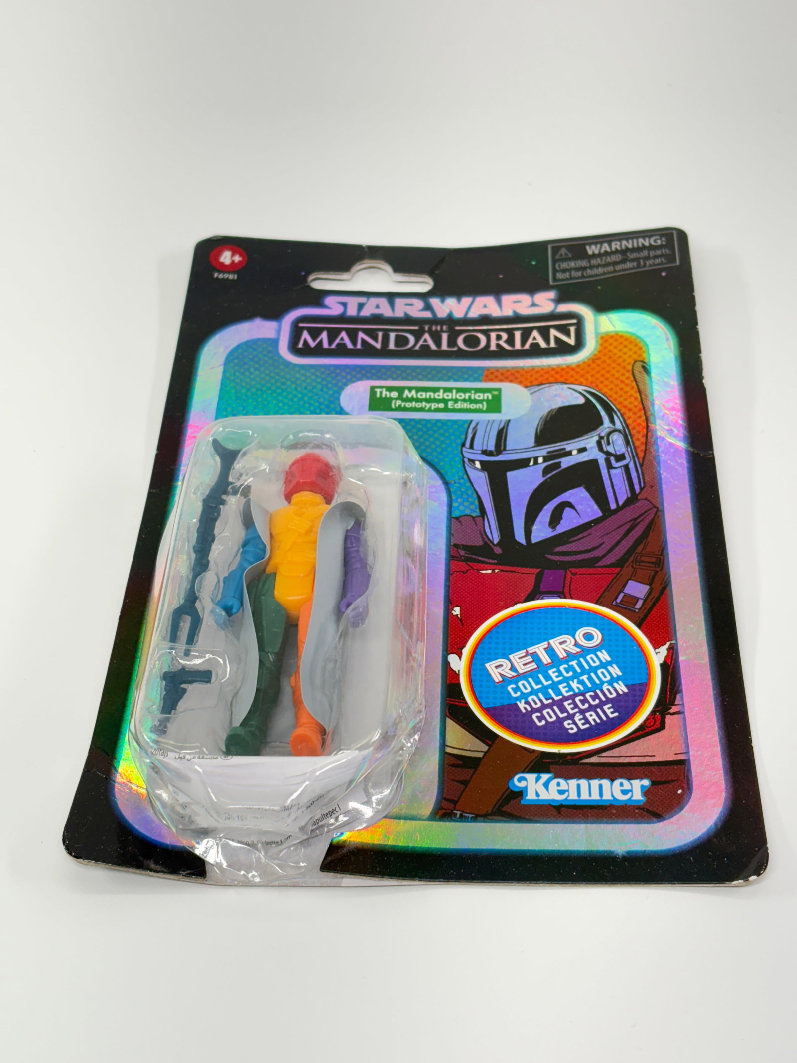 STAR WARS RETRO MANDALORIAN PROTOTYPE EDITION: REMAINS NEW IN PACKAGE, PACKAGING SHOWING WEAR THROUGHOUT.