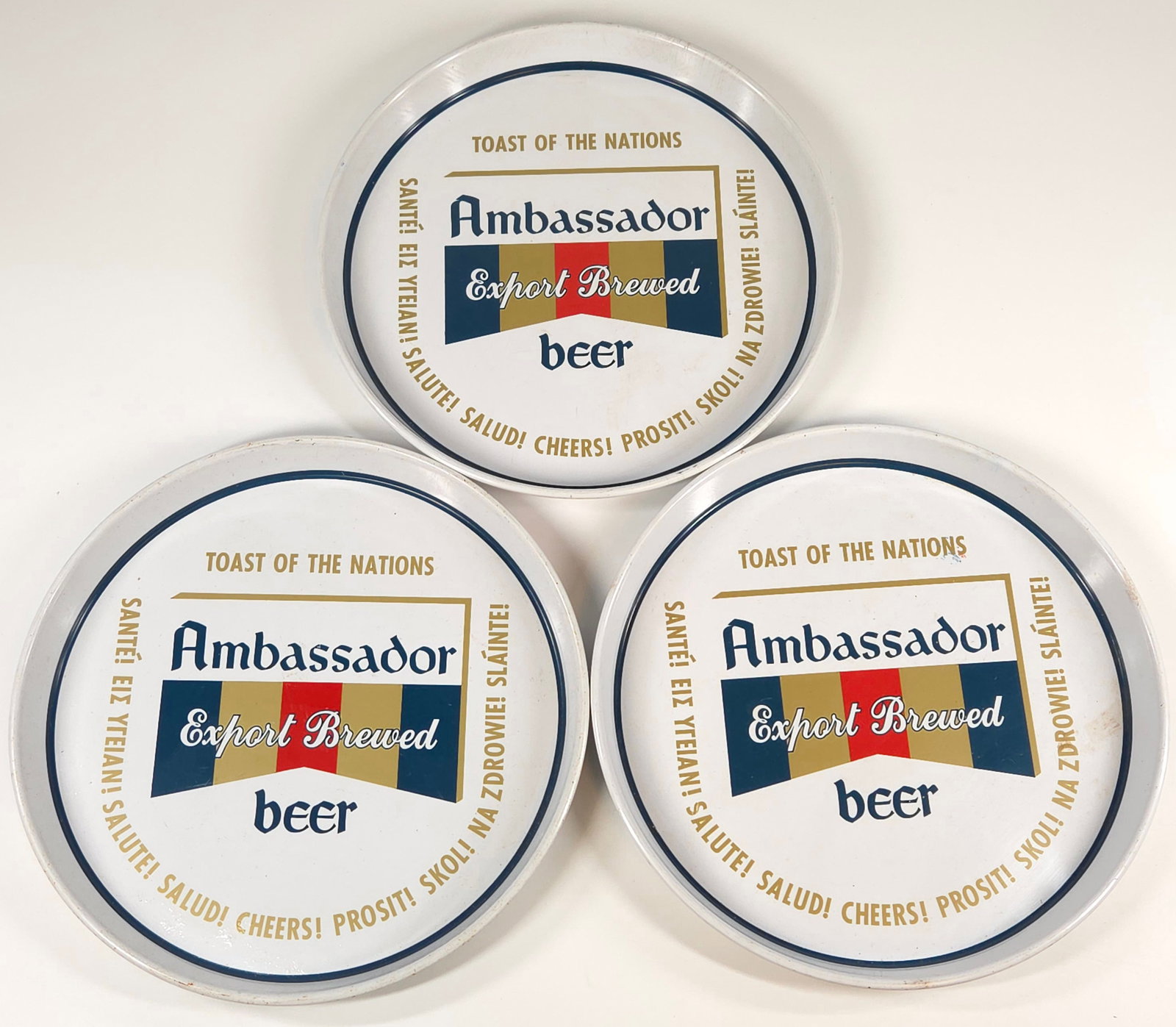 3) AMBASSADOR EXPORT BEER ADVERTISING TRAY: ALL REMAIN IN GOOD CONDITION, SHOWING ONLY SOME MINIMAL WEAR.