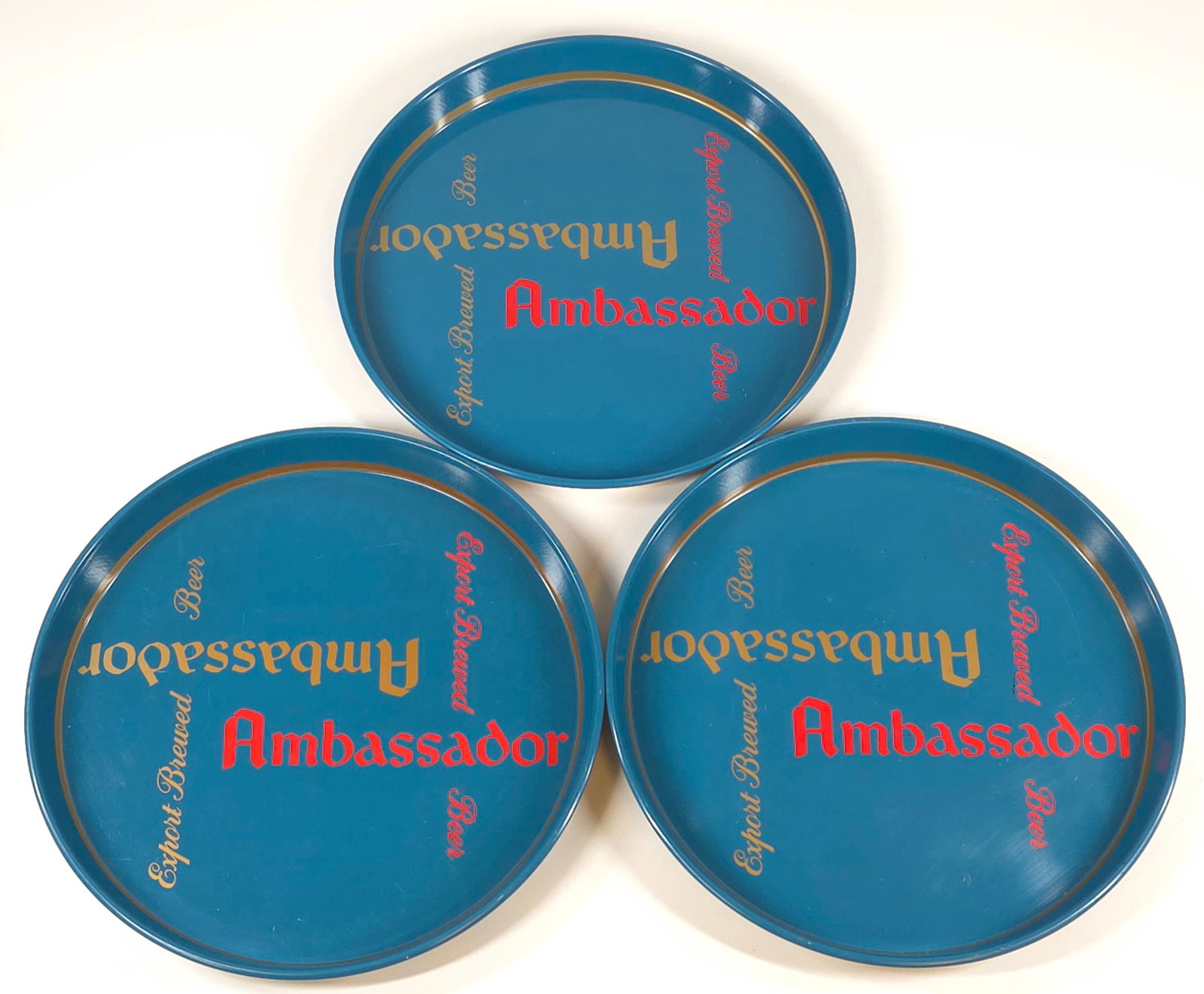 3) AMBASSADOR ADVERTISING BEER TRAY: ALL REMAIN IN GOOD CONDITION, SHOWING ONLY SOME MINIMAL WEAR.