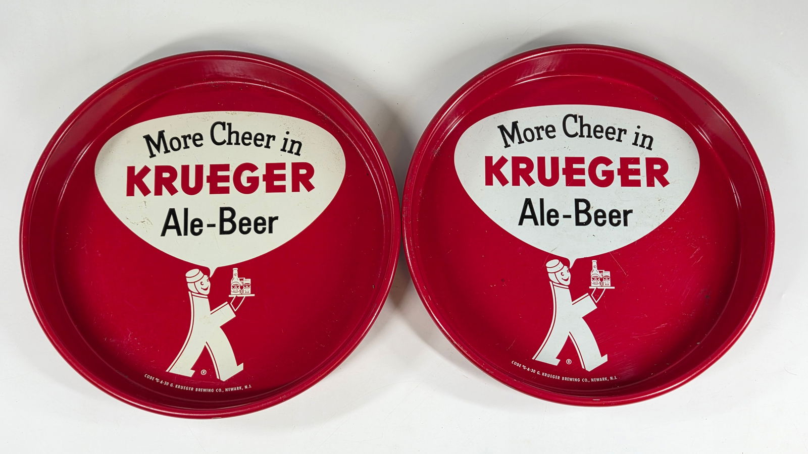 2) VINTAGE KRUEGER ALE-BEER ADVERTISING TRAYS: BOTH REMAIN IN GOOD CONDITION, SHOWING ONLY SOME MINIMAL WEAR.