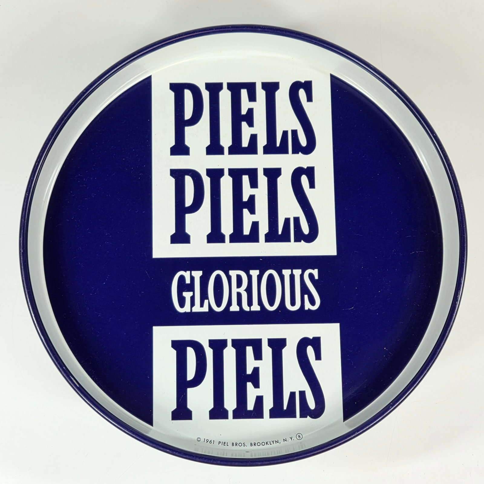 1961 PIEL BROS. PIELS PIELS GLORIOUS PIELS TRAY: REMAINS IN GOOD CONDITION, SHOWING SOME TYPICAL WEAR.