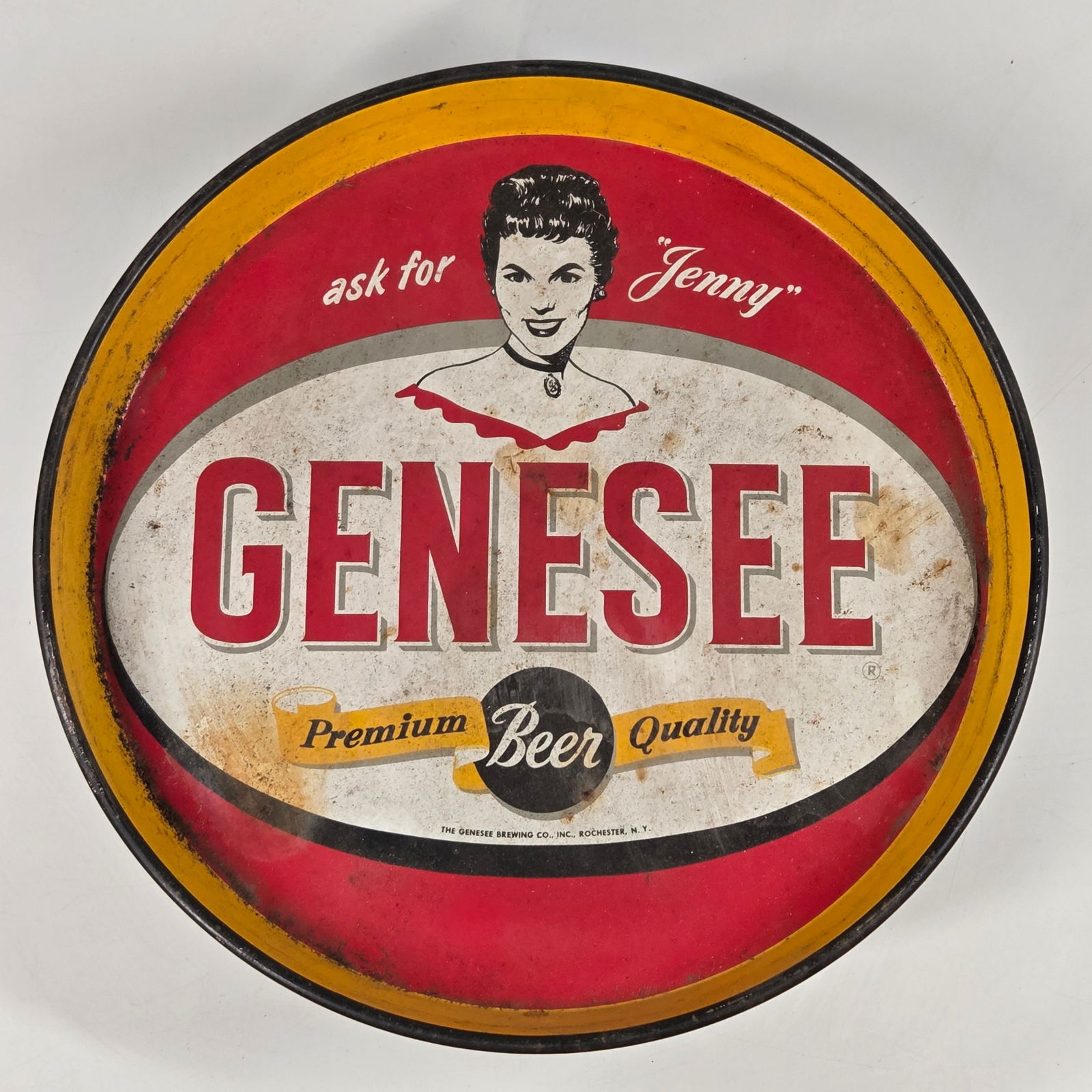 VINTAGE GENESEE ASK FOR "JENNY" BEER TRAY: REMAINS IN FAIR TO GOOD CONDITION, SHOWING WEAR AND SCRATCHES THROUGHOUT.