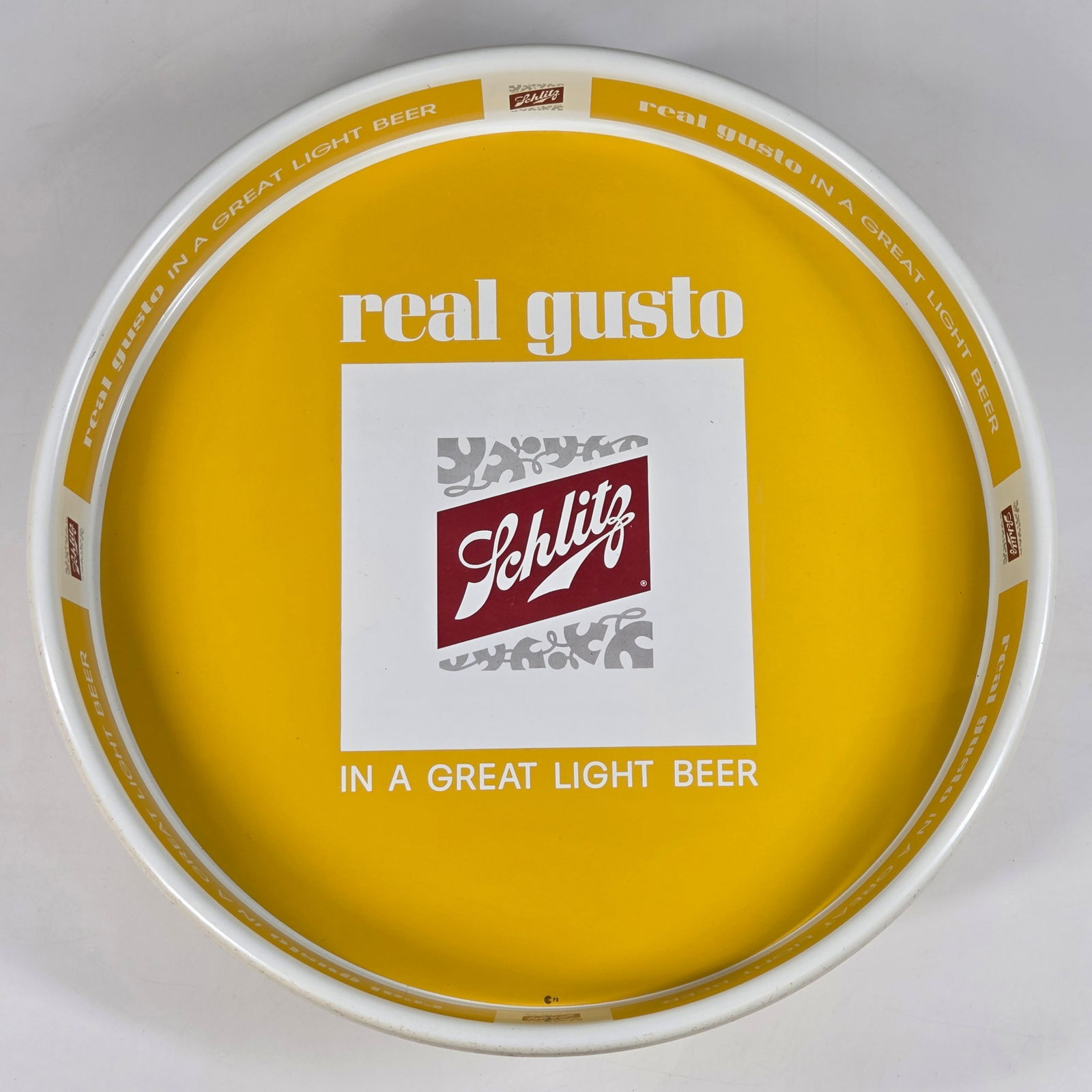SCHLITZ REAL GUSTO LIGHT BEER TRAY - YELLOW: REMAINS IN GOOD CONDITION, SHOWING SOME TYPICAL WEAR.