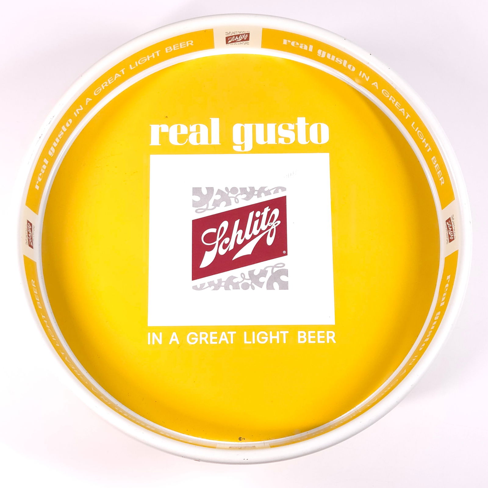 SCHLITZ REAL GUSTO LIGHT BEER TRAY - YELLOW: REMAINS IN GOOD CONDITION, SHOWING SOME TYPICAL WEAR.