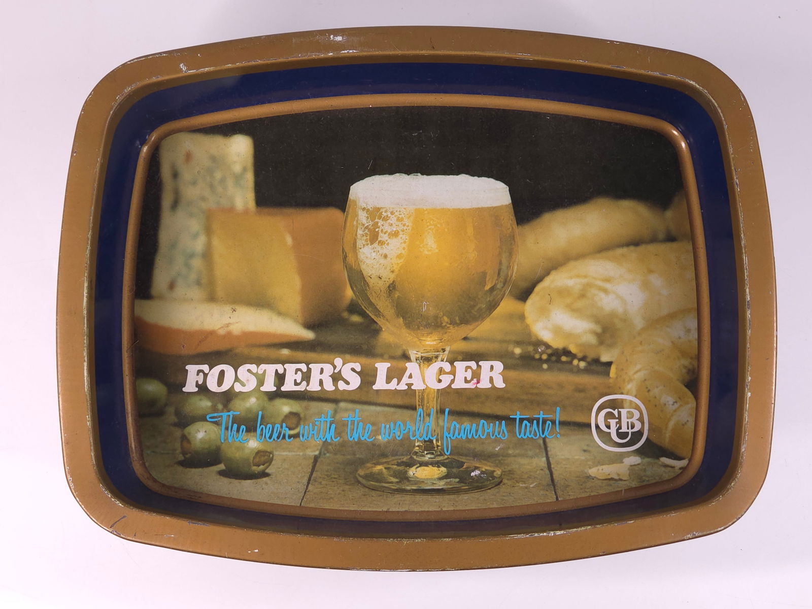 FOSTER'S LAGER ADVERTISING BEER TRAY: REMAINS IN FAIR TO GOOD CONDITION, SHOWING WEAR AND SCRATCHES THROUGHOUT.