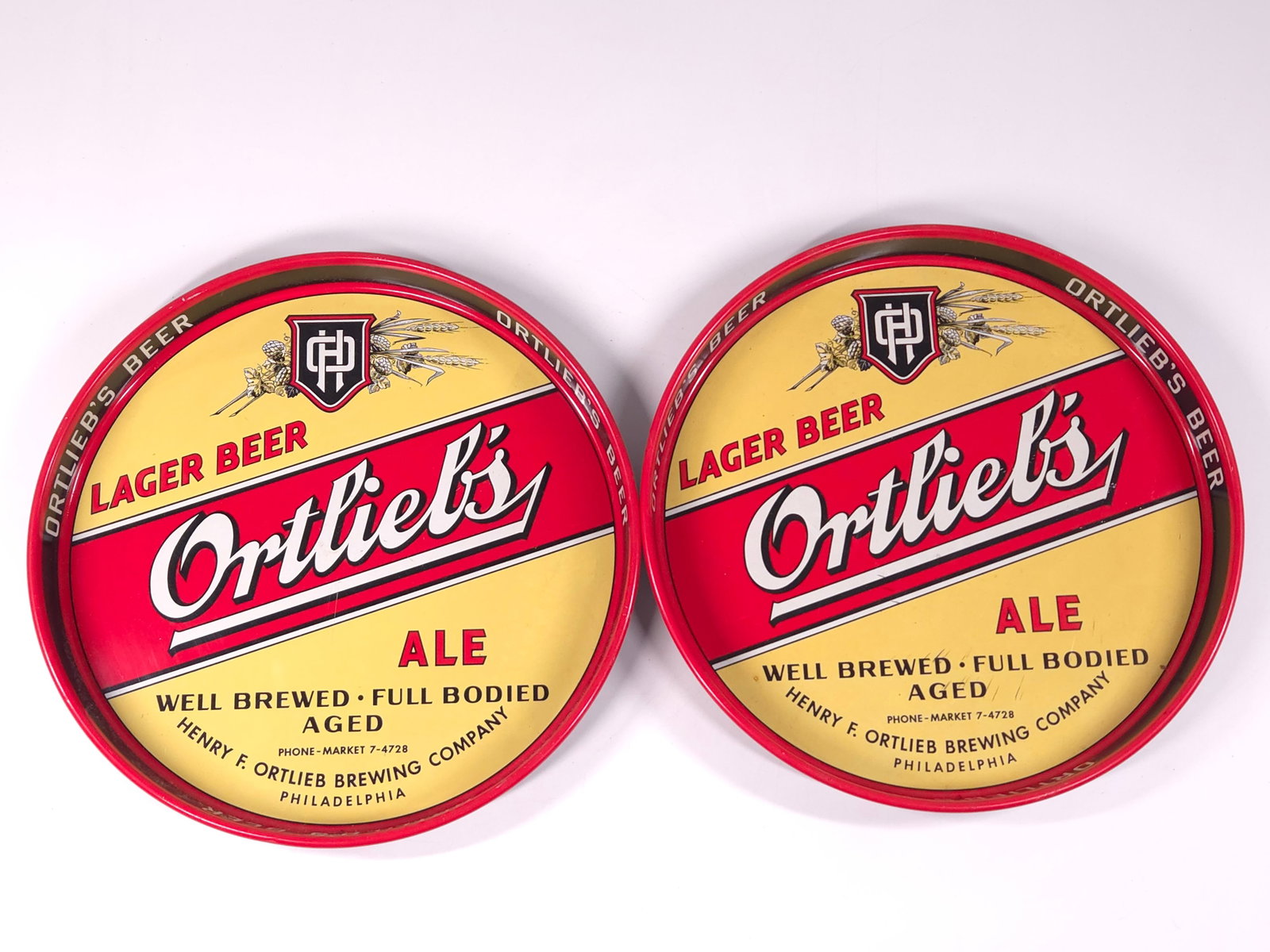 2) VINTAGE ORTLIEB'S ADVERTISING ALE TRAYS: BOTH REMAIN IN GOOD CONDITION, SHOWING ONLY SOME MINIMAL WEAR.