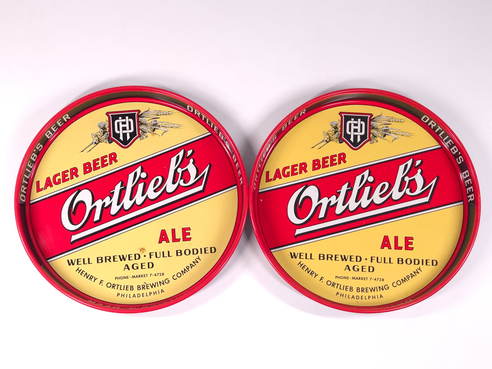 2) VINTAGE ORTLIEB'S ADVERTISING ALE TRAYS: BOTH REMAIN IN GOOD CONDITION, SHOWING ONLY SOME MINIMAL WEAR.
