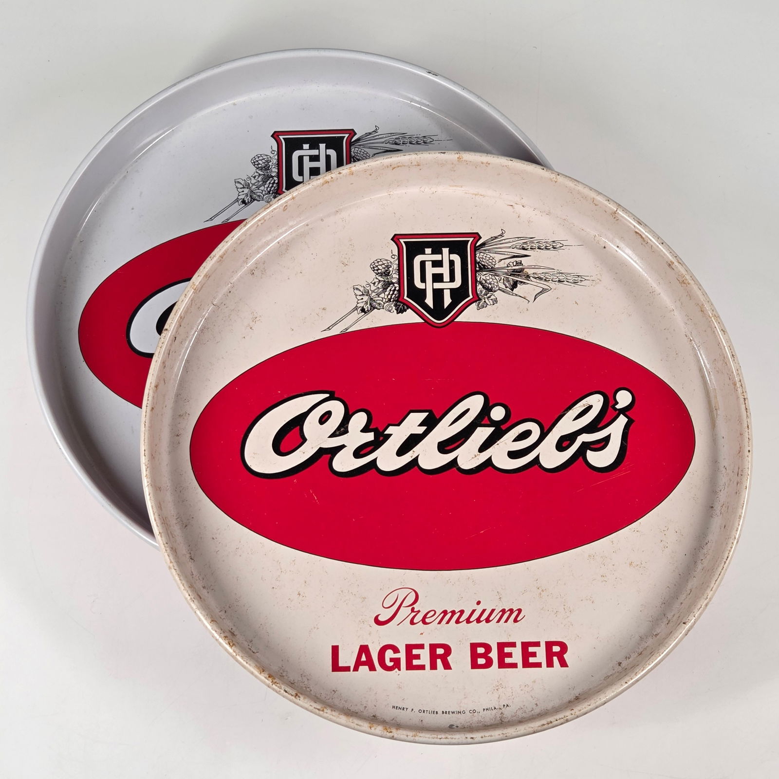 HENRY ORTLIEB PREMIUM LAGER BEER TRAYS: ONE REMAINS IN EXCELLENT CONDITION, THE OTHER SHOWING SOME TYPICAL WEAR.