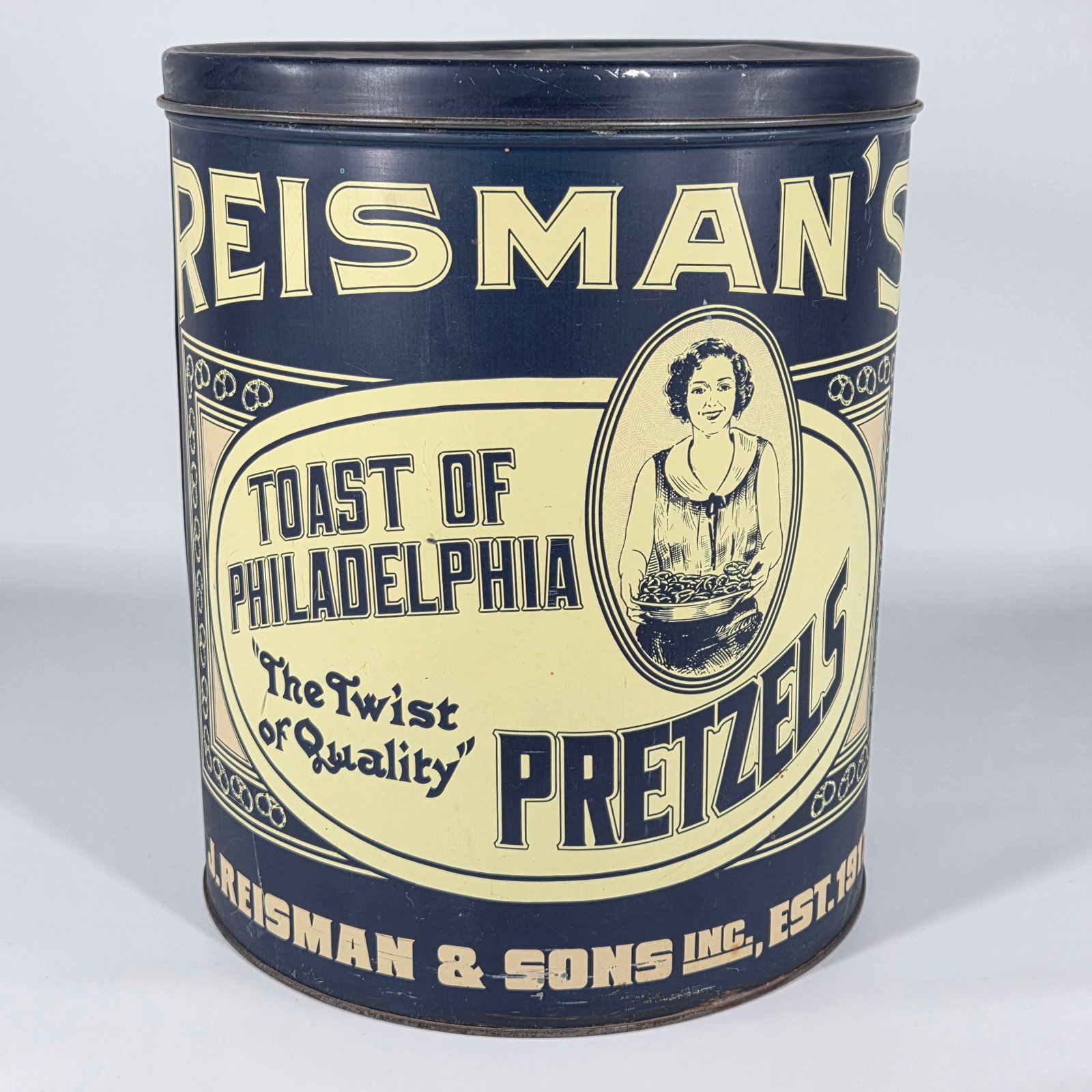 J. REISMAN & SONS ADVERTISING PRETZEL TIN: REMAINS IN GOOD CONDITION, SHOWING SOME TYPICAL WEAR.