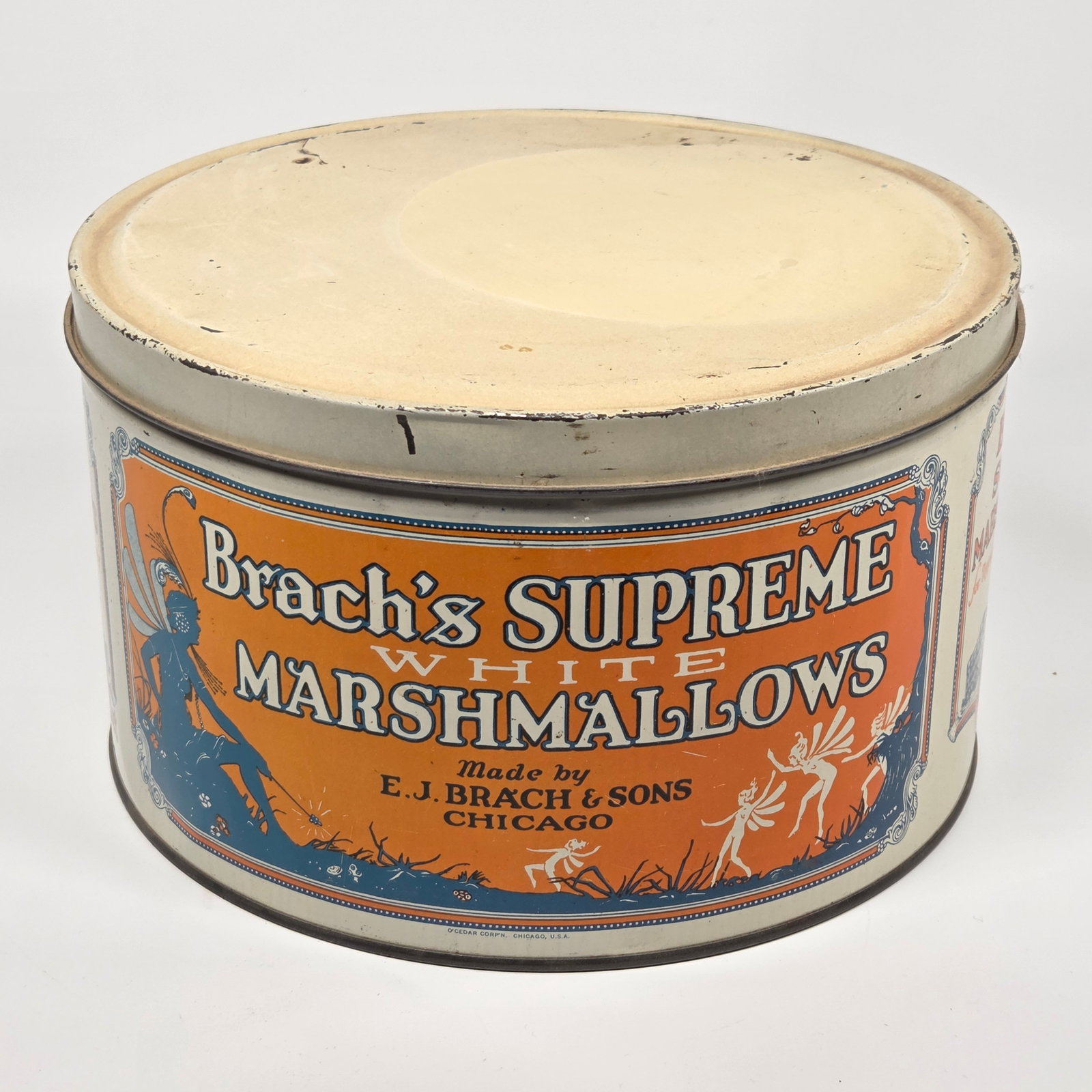 E.J. BRACH'S SUPREME MARSHMALLOWS TIN W/ PIXIES: REMAINS IN GOOD CONDITION, SHOWING SOME TYPICAL WEAR.