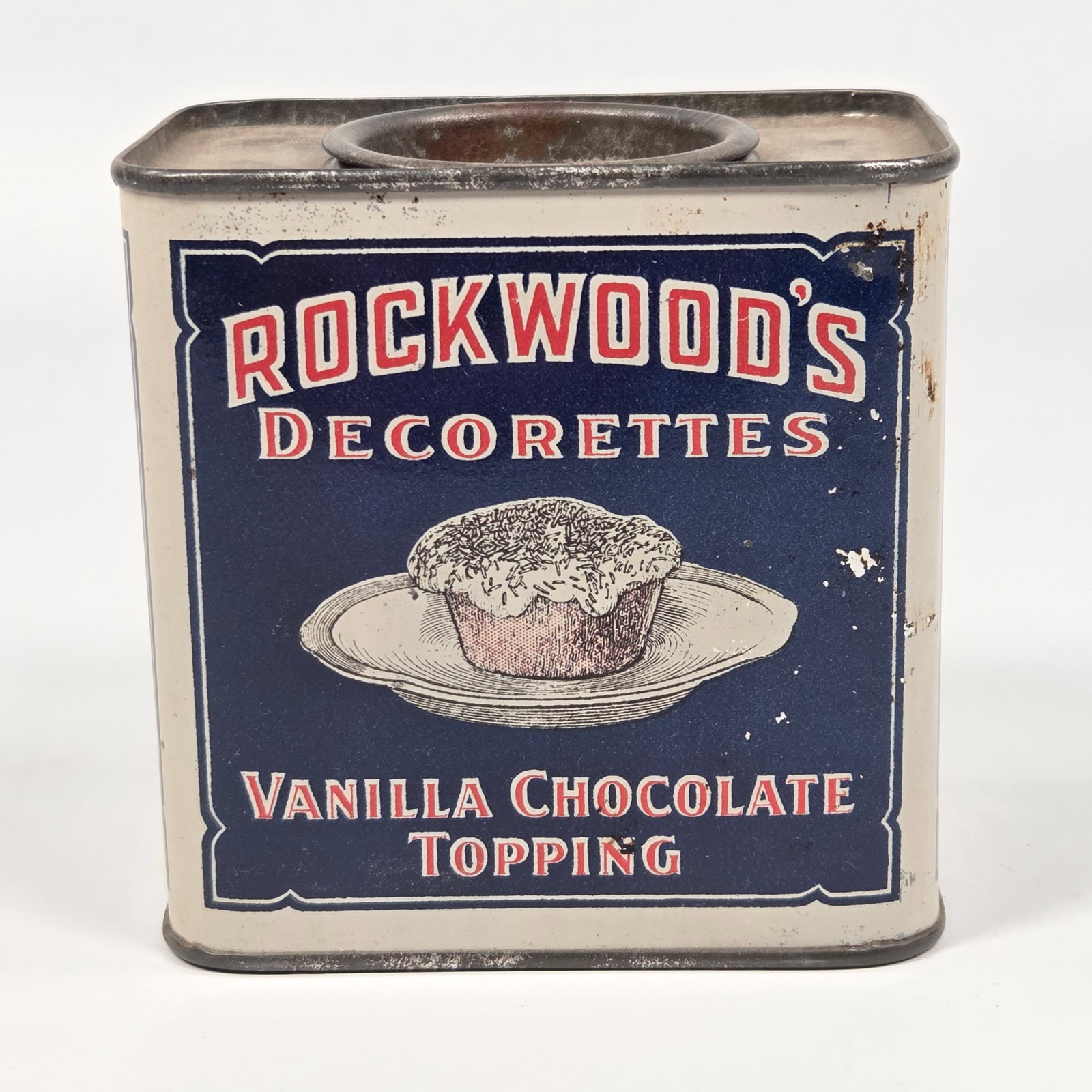ROCKWOOD'S DECORETTES VANILLA CHOCOLATE TOPPING TIN: REMAINS IN GOOD CONDITION, SHOWING SOME TYPICAL WEAR.