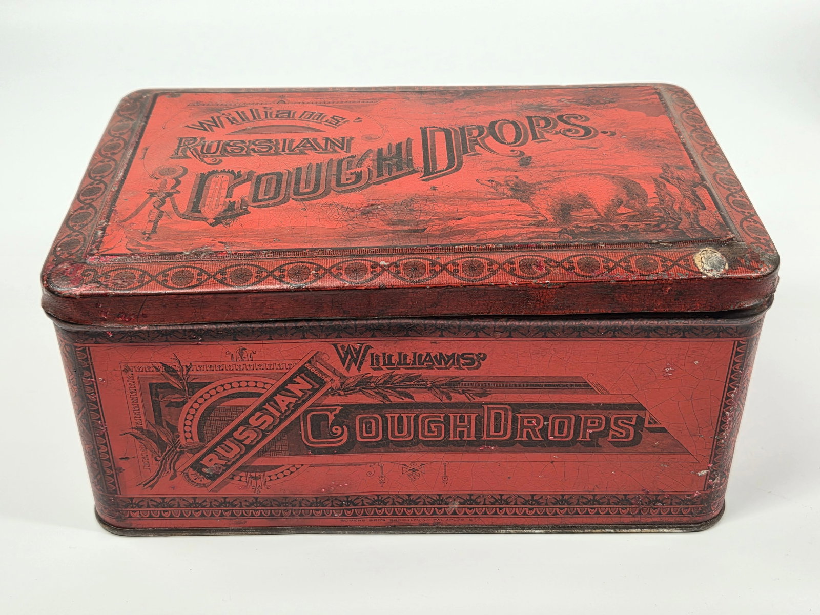 WILLIAMS' RUSSIAN COUGH DROPS ADVERTISING TIN: REMAINS IN FAIR TO GOOD CONDITION, SHOWING SOME TYPICAL WEAR.