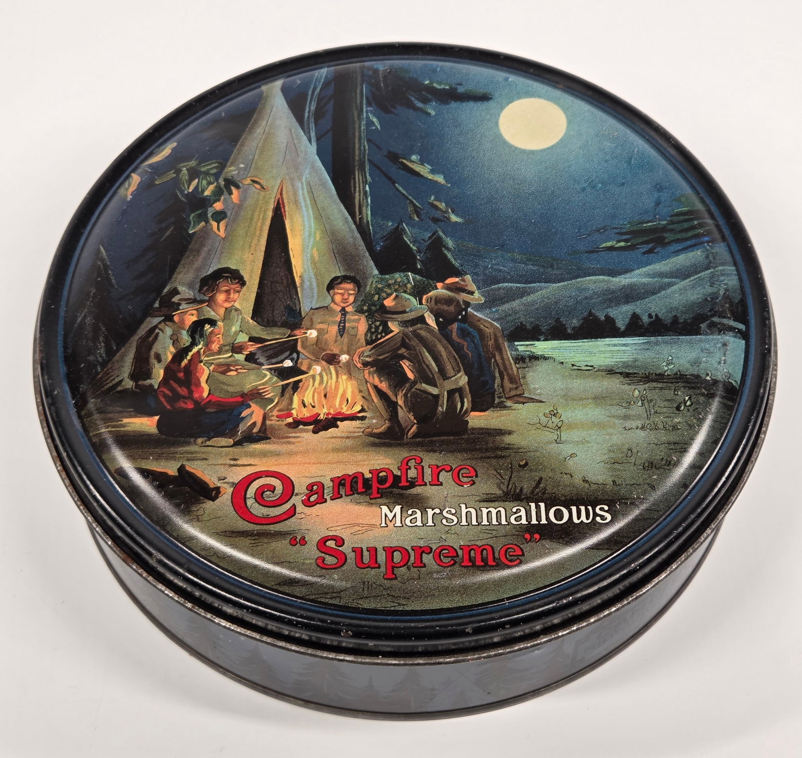 BOY SCOUT & NATIVE AMERICAN CAMPFIRE MARSHMALLOW TIN: REMAINS IN GOOD CONDITION, SHOWING SOME TYPICAL WEAR.
