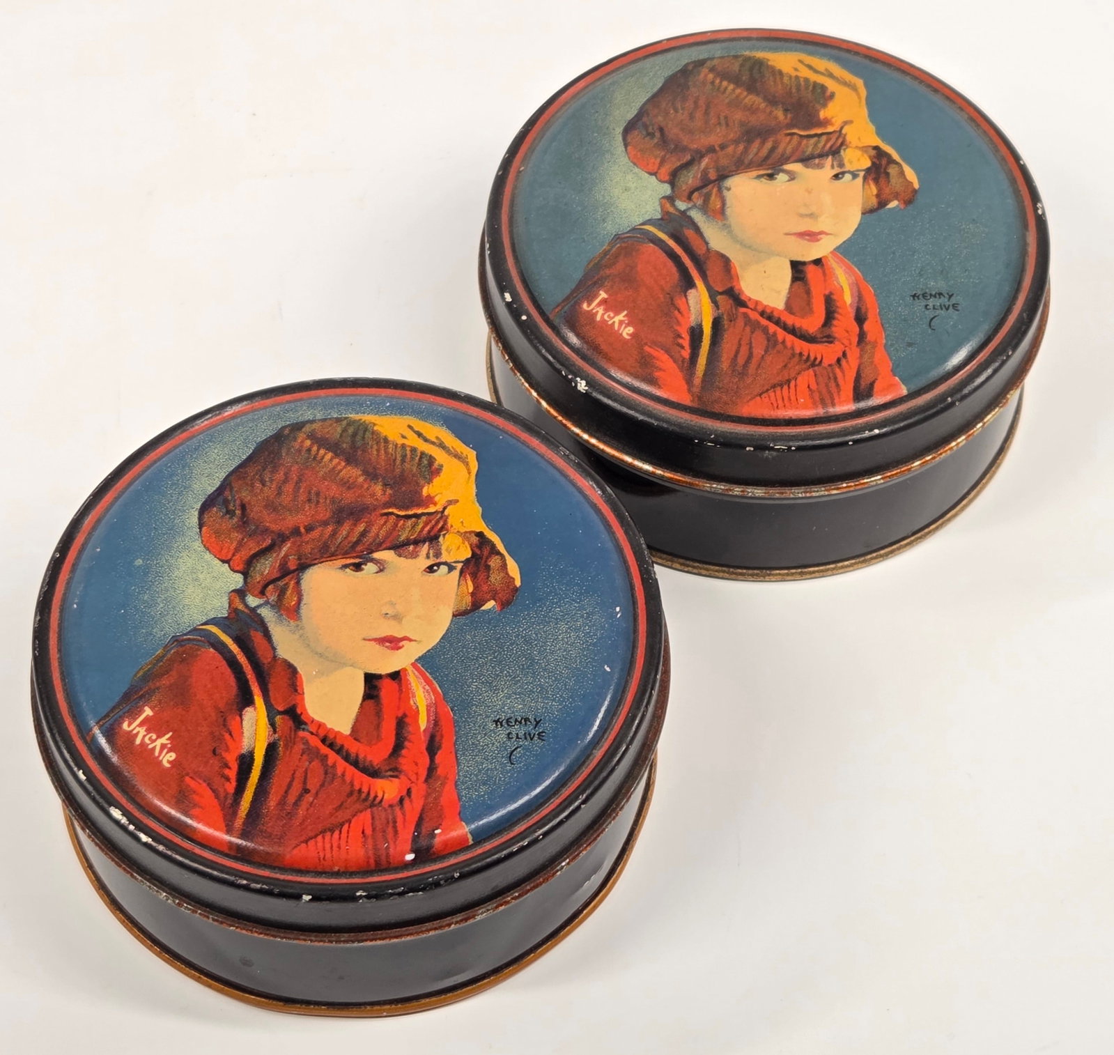 2) JACKIE COOGAN ADVERTISING TINS: BOTH REMAIN IN GOOD CONDITION, SHOWING SOME TYPICAL WEAR.