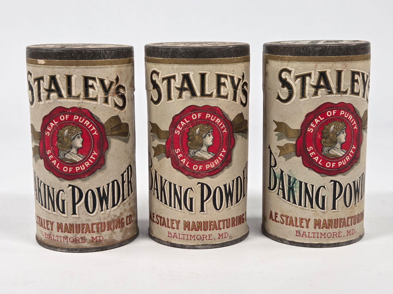 3) STALEY'S BAKING POWDER TINS W/ PAPER LABELS: ALL REMAIN IN GOOD CONDITION, SHOWING SOME TYPICAL WEAR.