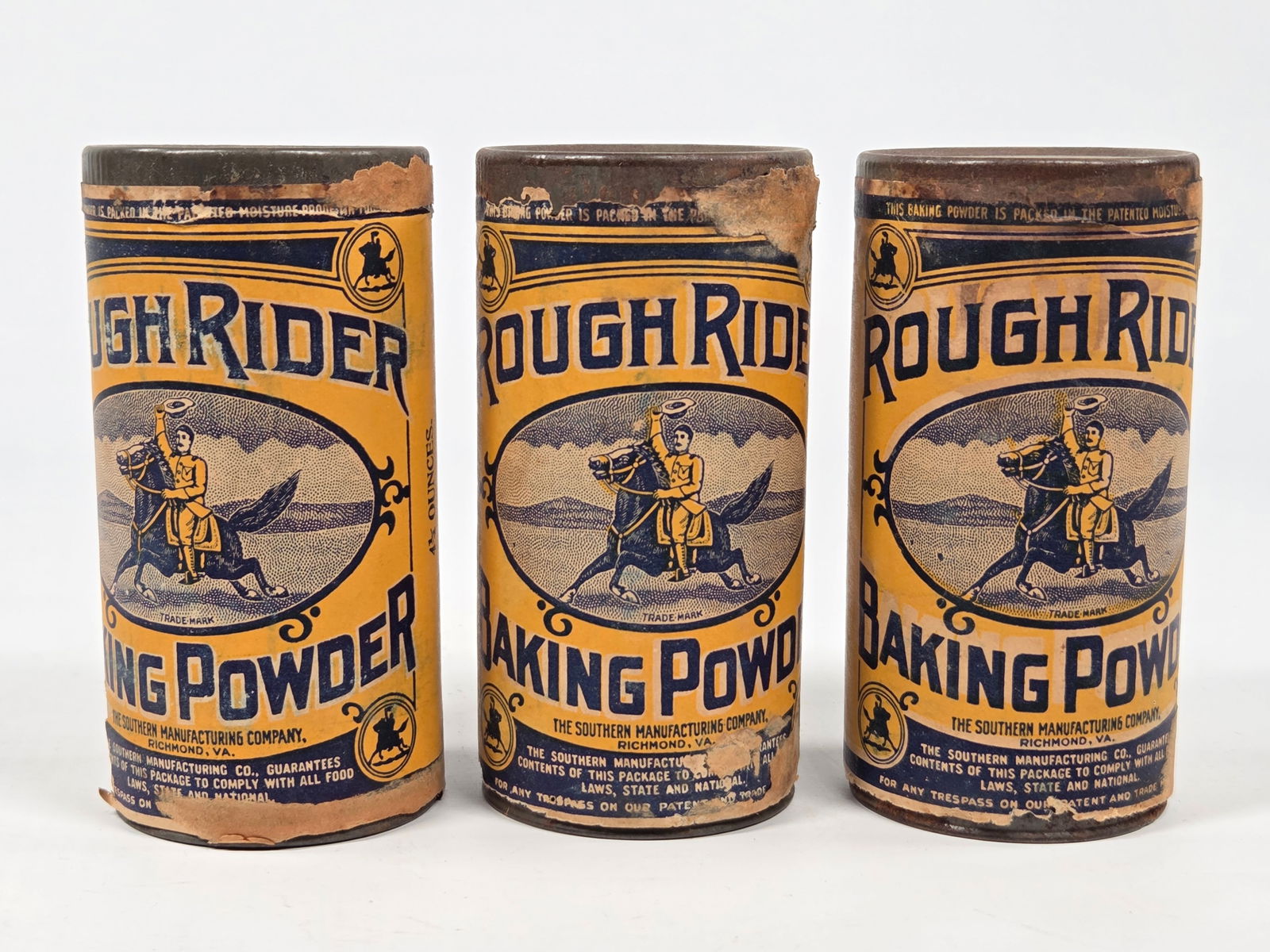 3) ROUGH RIDER BAKING POWDER 4 1/4 OZ. CONTAINERS - UNOPENED: ALL REMAIN IN FAIR TO GOOD UNOPENED CONDITION. PAPER LABELS SHOWING SOME WEAR AND SOME TEARS.