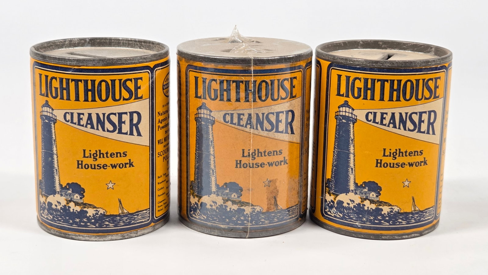 3) LIGHTHOUSE CLEANSER ADVERTISING TIN BANKS: ALL REMAIN IN GOOD CONDITION, SHOWING SOME TYPICAL WEAR.