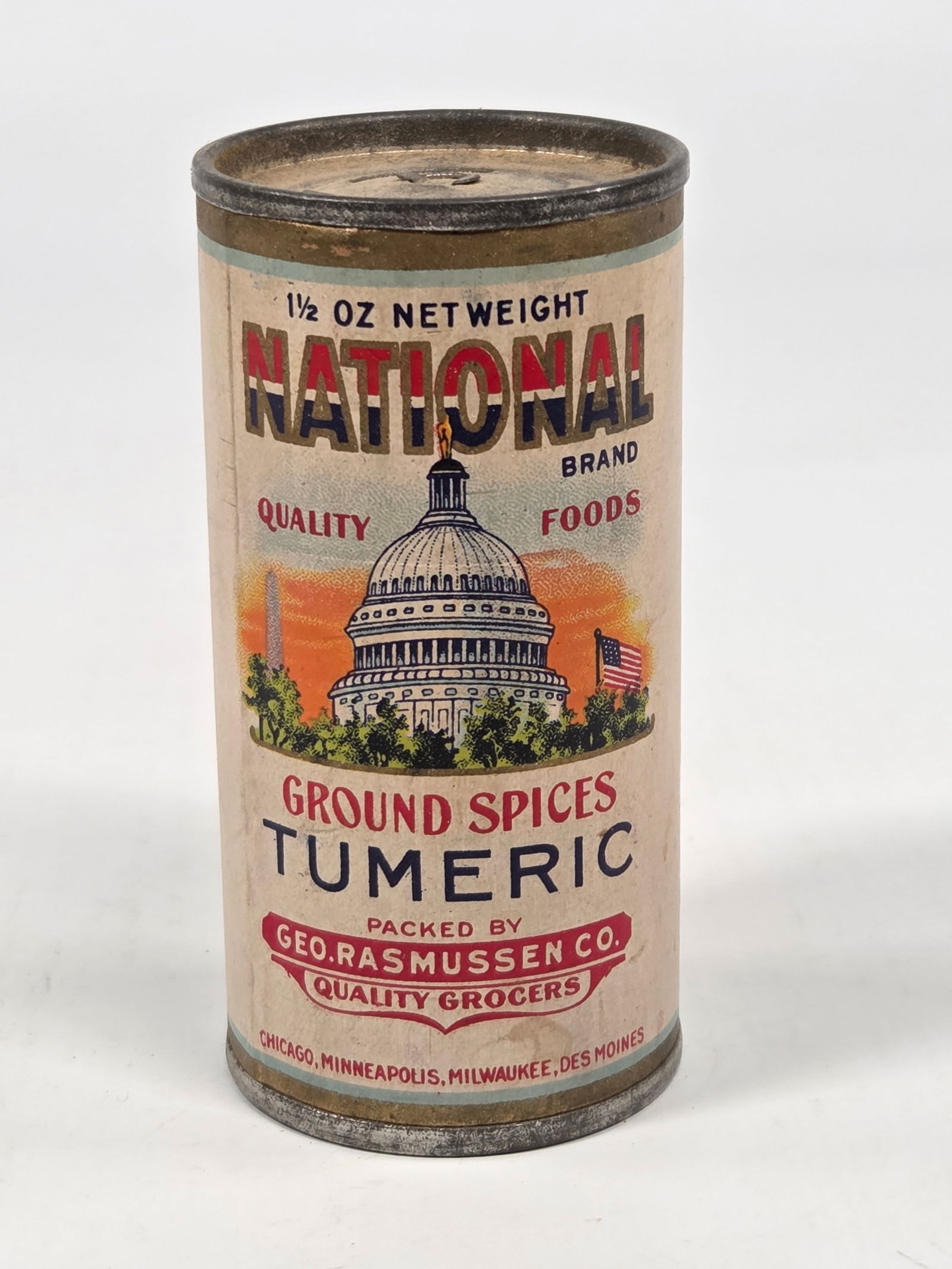 GEO. RASMUSSEN CO. NATIONAL TUMERIC SPICE TIN W/ PAPER LABEL: REMAINS IN GOOD CONDITION, SHOWING SOME TYPICAL WEAR.