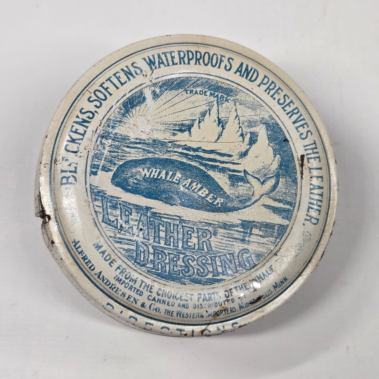 WHALE AMBER LEATHER DRESSING TIN TURNED TAPE MEASURE: REMAINS IN FAIR TO GOOD CONDITION, SHOWING SOME TYPICAL WEAR.