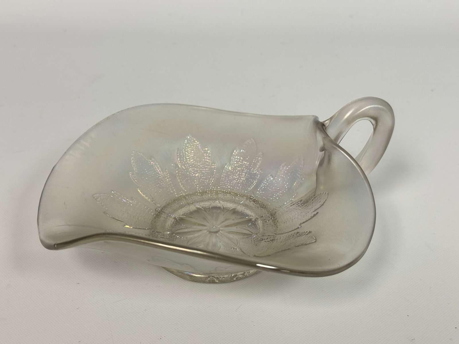 DUGAN LEAF RAYS CARNIVAL GLASS HANDLE CANDY DISH: REMAINS IN VERY GOOD CONDITION, NO CHIPS OR CRACKS.