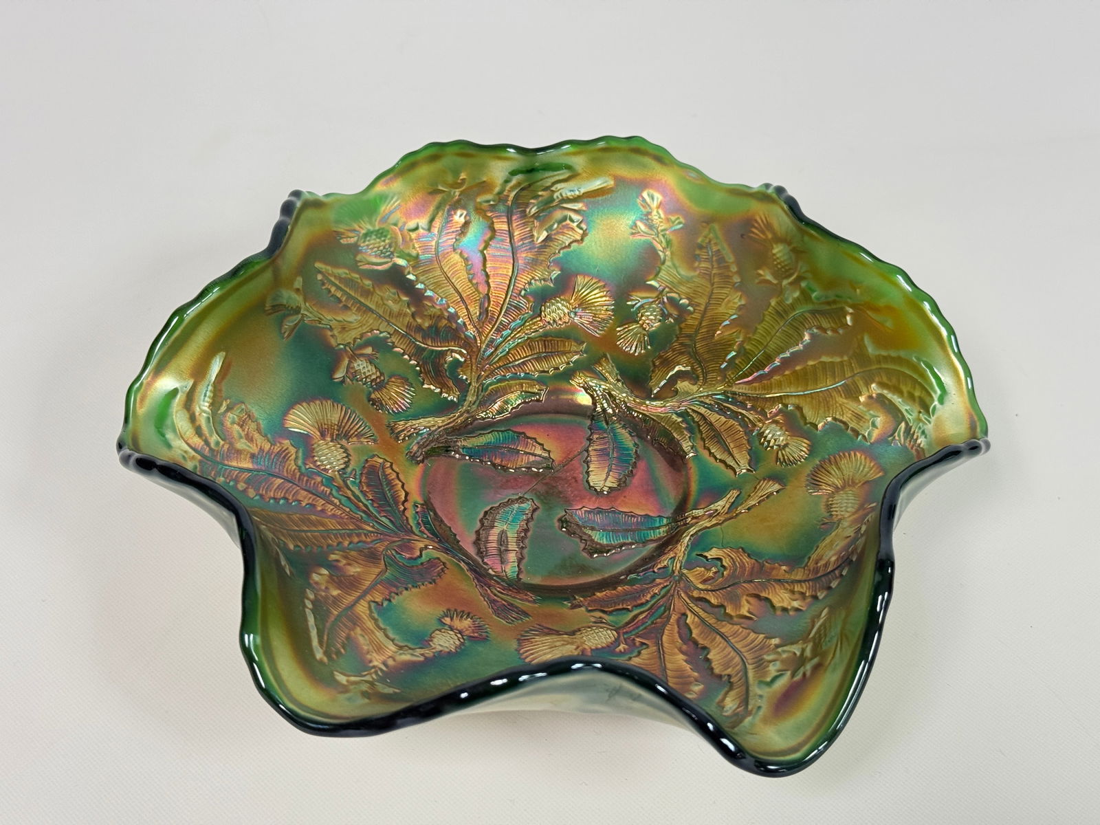 FENTON THISTLE PATTERN GREEN CARNIVAL GLASS BOWL: REMAINS IN VERY GOOD CONDITION, NO CHIPS OR CRACKS.