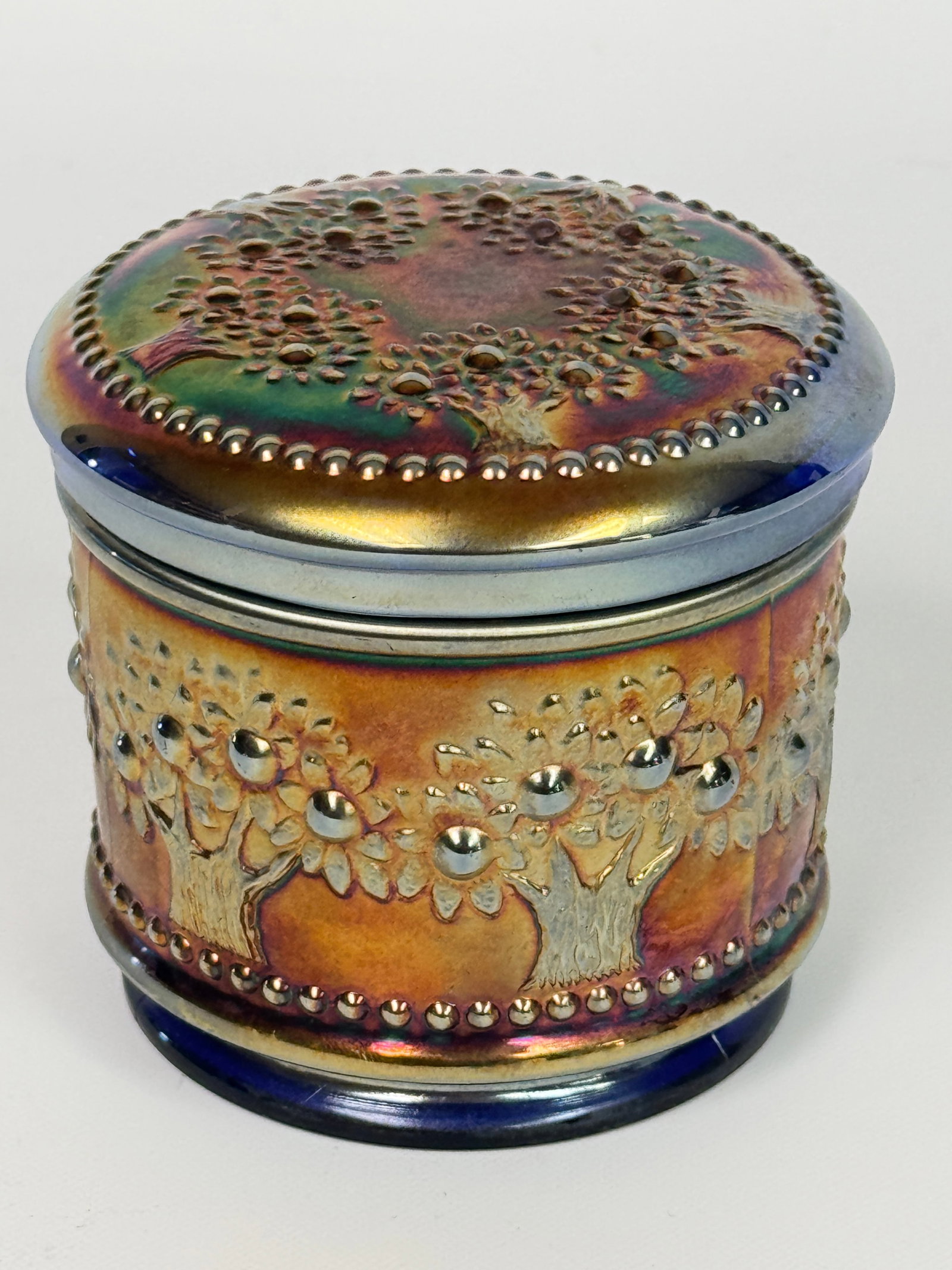 FENTON ORANGE TREE BLUE CARNIVAL GLASS POWDER JAR: REMAINS IN VERY GOOD CONDITION, NO CHIPS OR CRACKS.