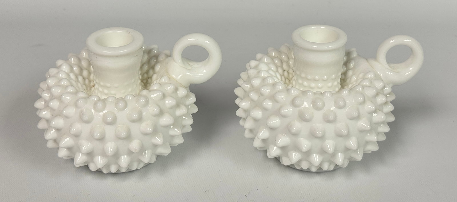 PAIR OF WHITE MILK GLASS HOBNAIL CANDLE HOLDERS: BOTH REMAIN IN GOOD CONDITION, NO CHIPS OR CRACKS. NEEDING CLEANED.