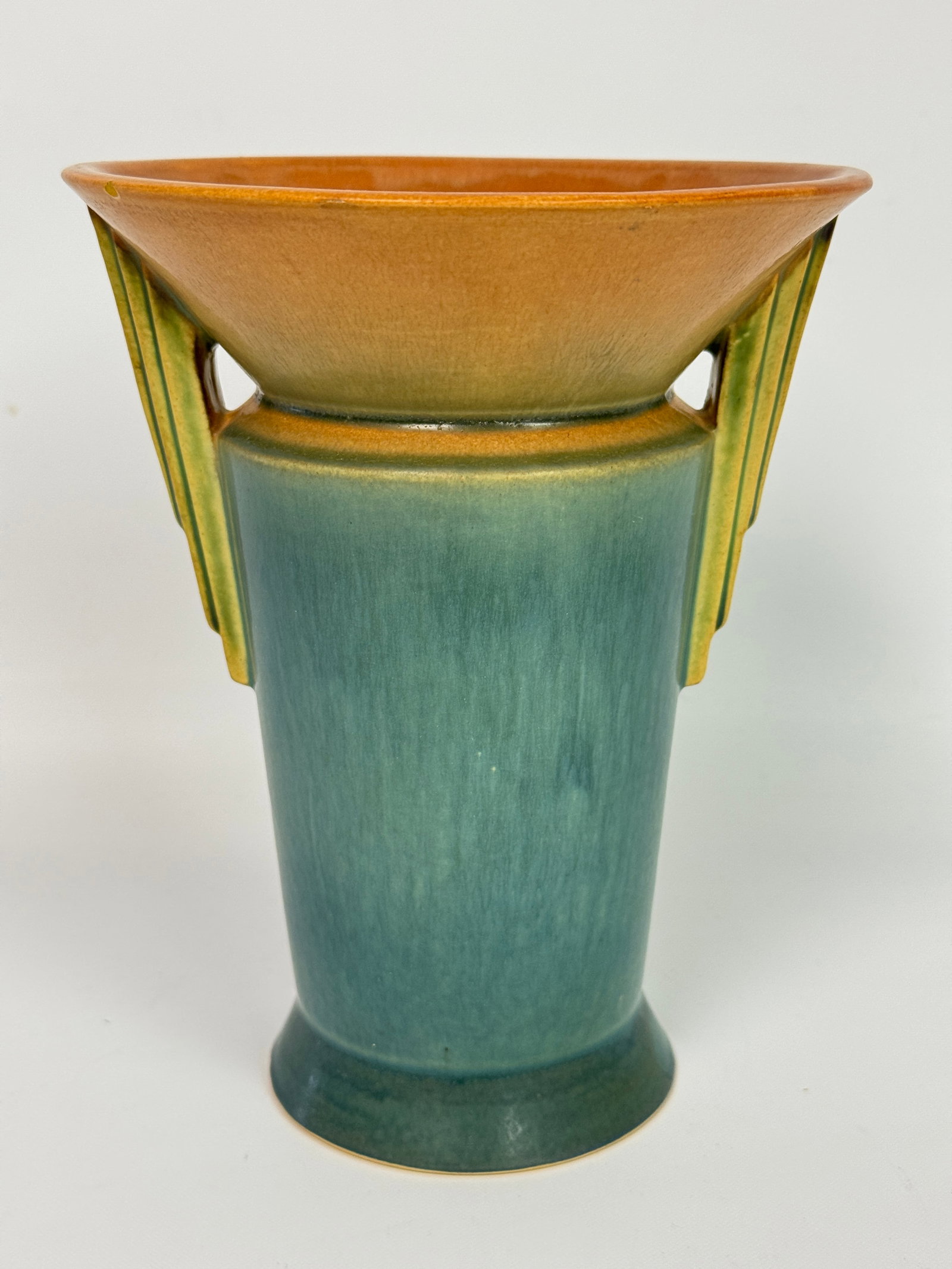 ROSEVILLE ART POTTERY FUTURA WINGED ART DECO VASE: REMAINS IN VERY GOOD CONDITION, HOWEVER SHOWS A SMALL MICRO CHIP IN GLAZE FINISH ON EDGE RIM. NO CRACKS.