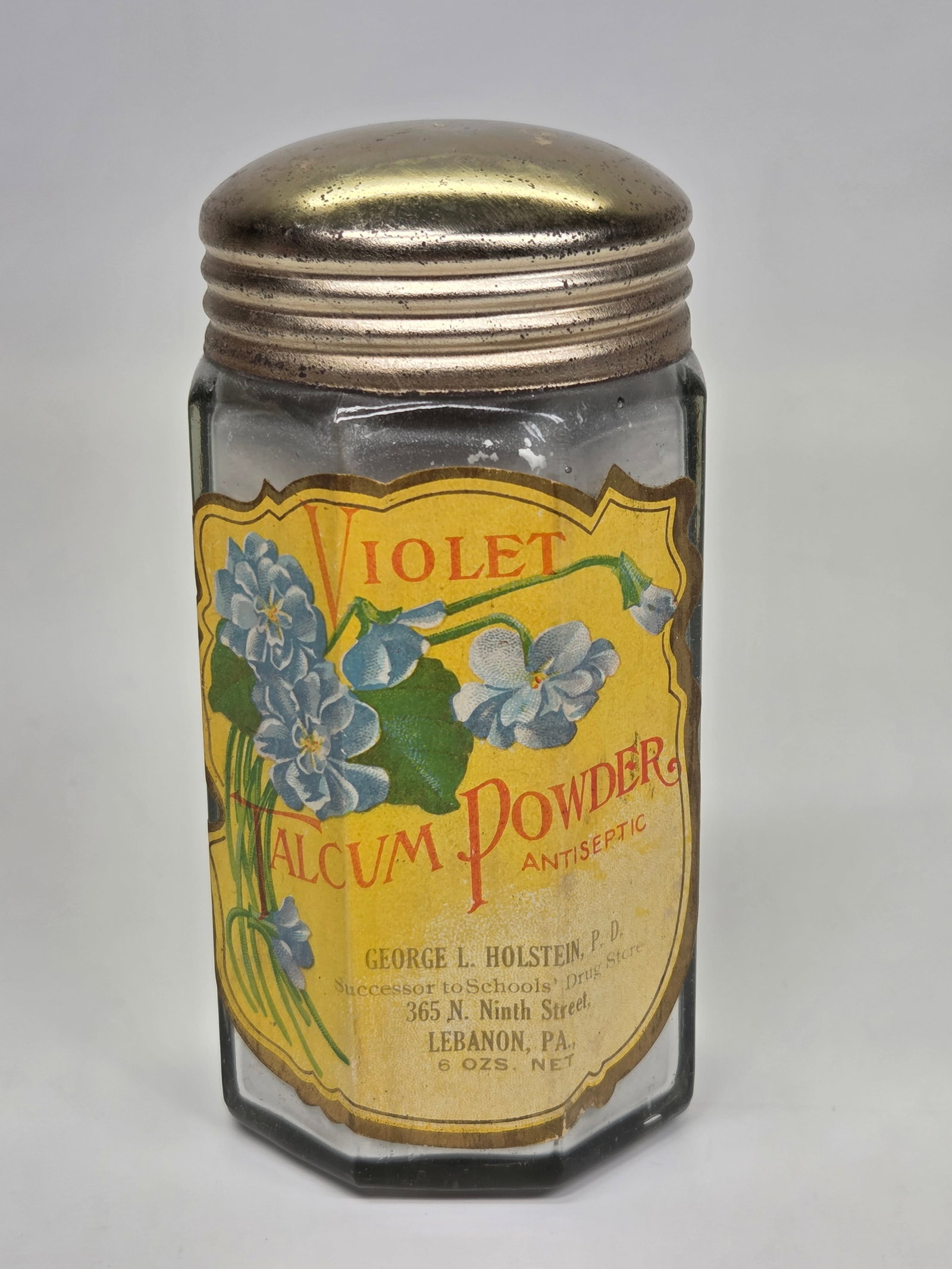 GEORGE L. HOLSTEIN P.D. LEBANON PA VIOLET TALCUM POWDER JAR: REMAINS IN GOOD CONDITION WITH ORIGINAL LABEL. FULL. ORIGINAL LABEL REMAINS NICE.