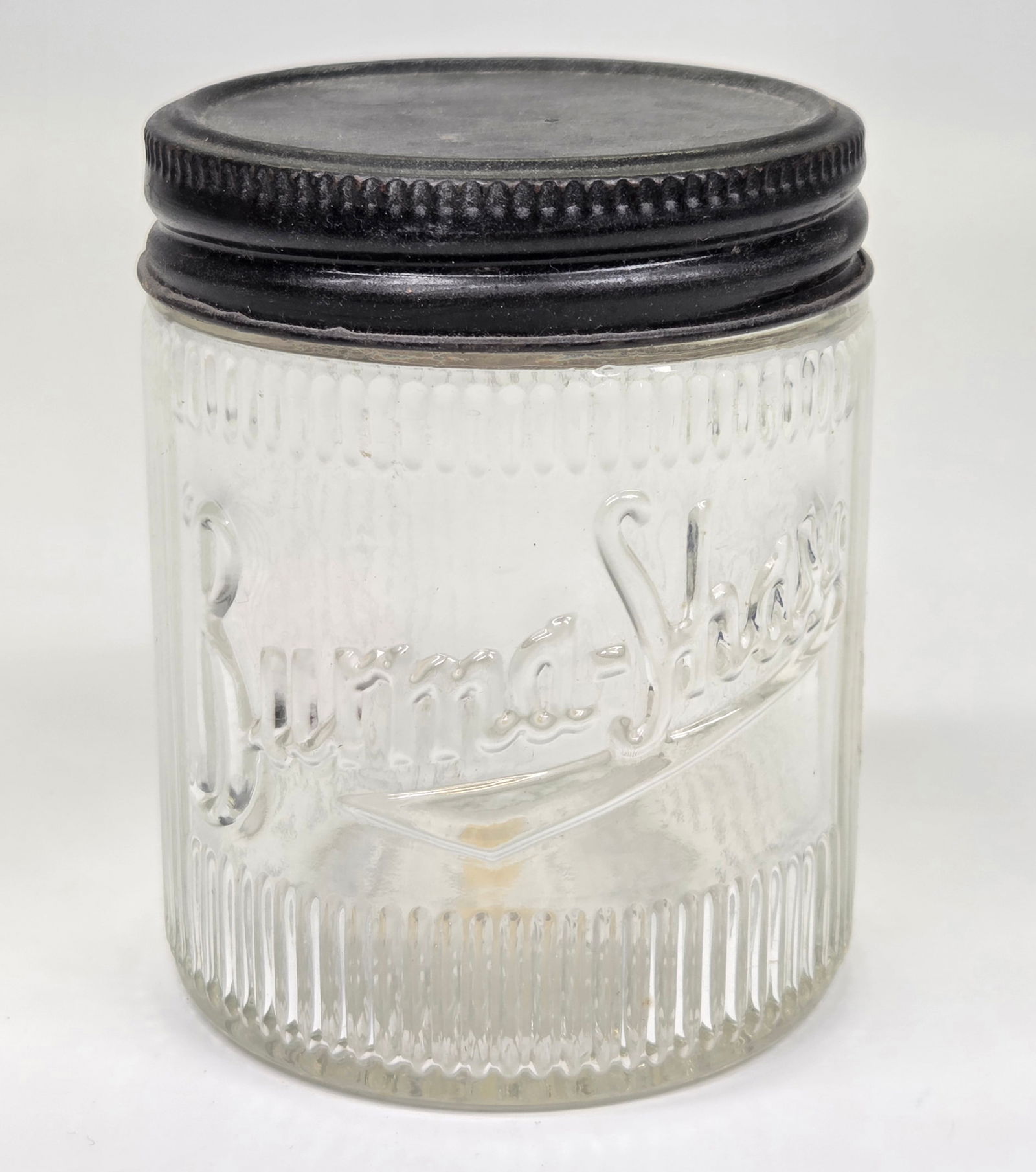 BURMA SHAVE ADVERTISING GLASS JAR W/ LID: REMAINS IN GOOD CONDITION.