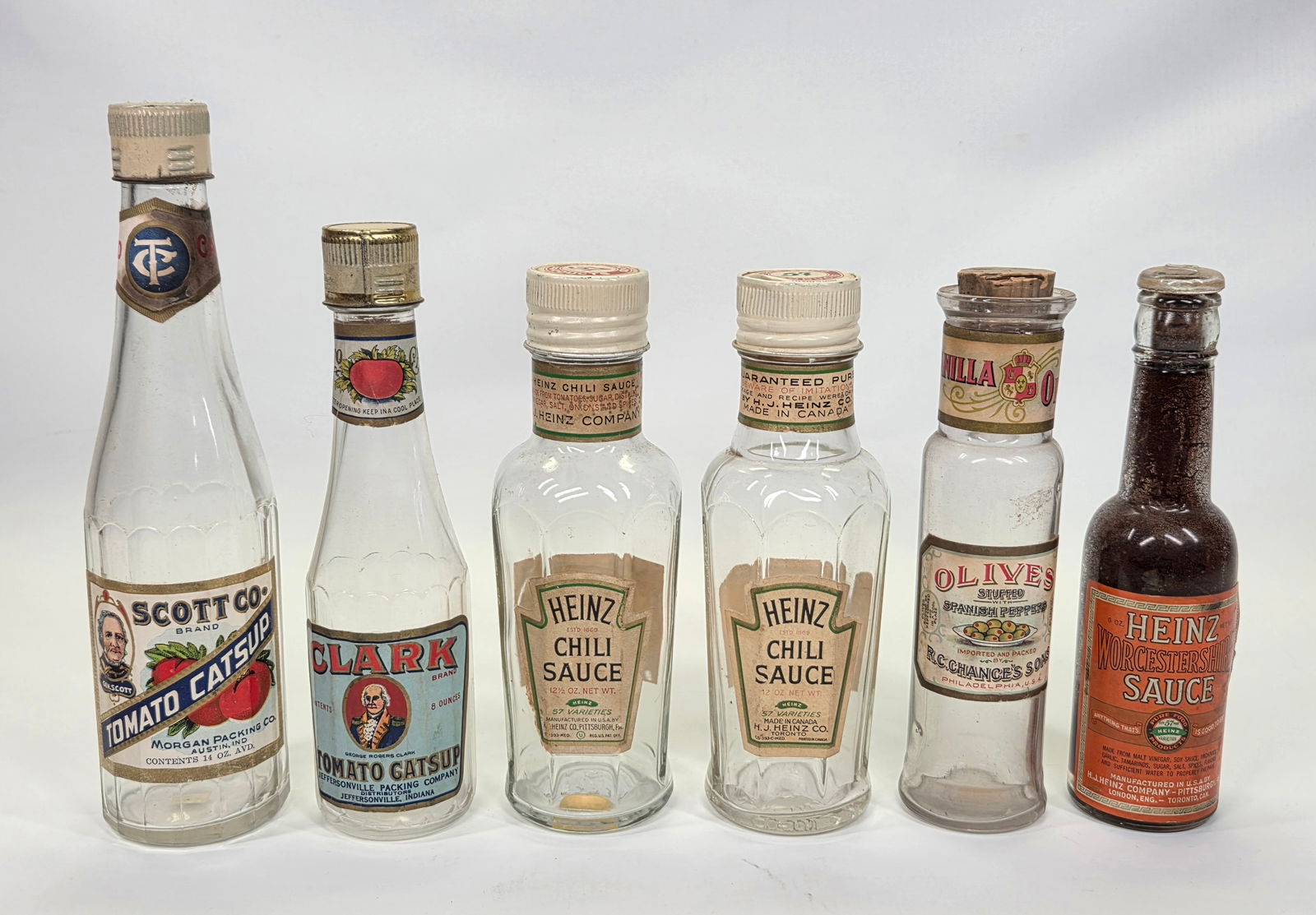 VARIOUS ADVERTISING CONDIMENT GLASS BOTTLES: ALL REMAIN IN GOOD CONDITION WITH ORIGINAL PAPER LABELS. LABELS SHOWING SOME WEAR.