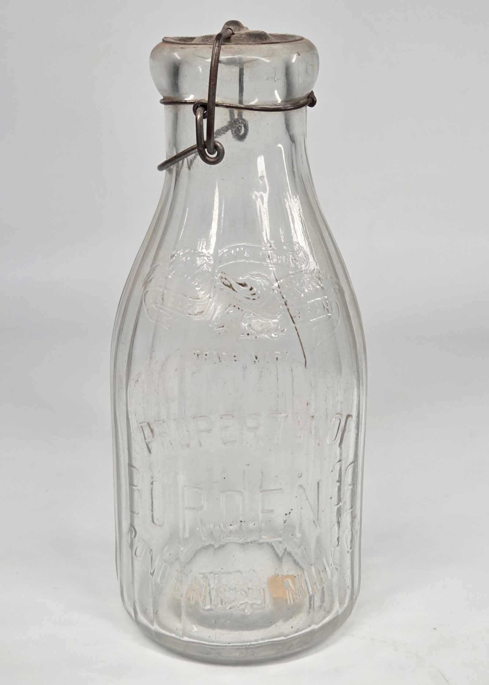 ANTIQUE PROPERTY OF BORDEN'S GLASS MILK BOTTLE: REMAINS IN GOOD CONDITION, SHOWING SOME TYPICAL WEAR. NO CHIPS OR CRACKS.