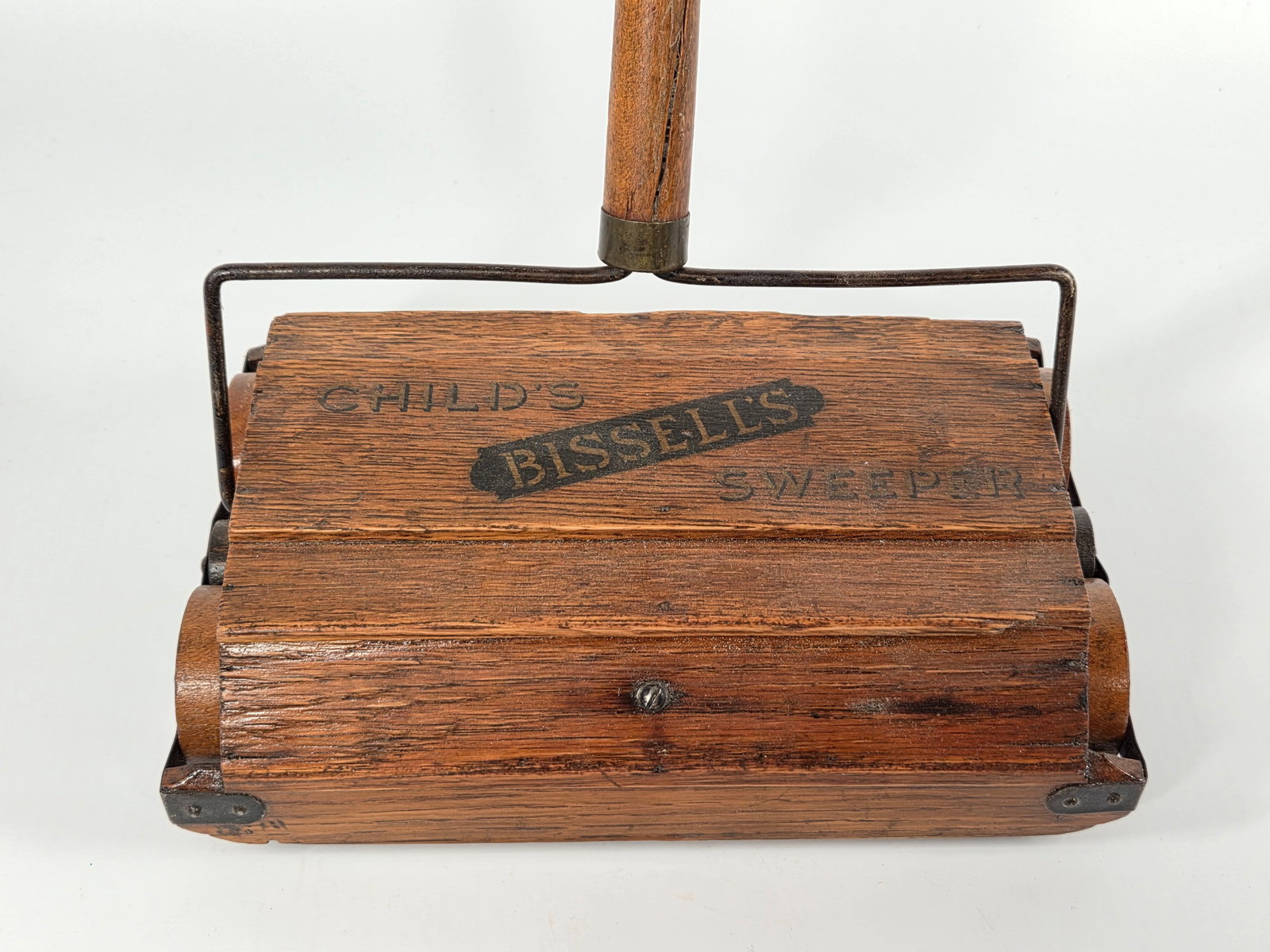 ANTIQUE OAK CHILD'S BISSELL'S SWEEPER: REMAINS IN GOOD CONDITION, SHOWING SOME TYPICAL WEAR. CRACK IN THE HANDLE.