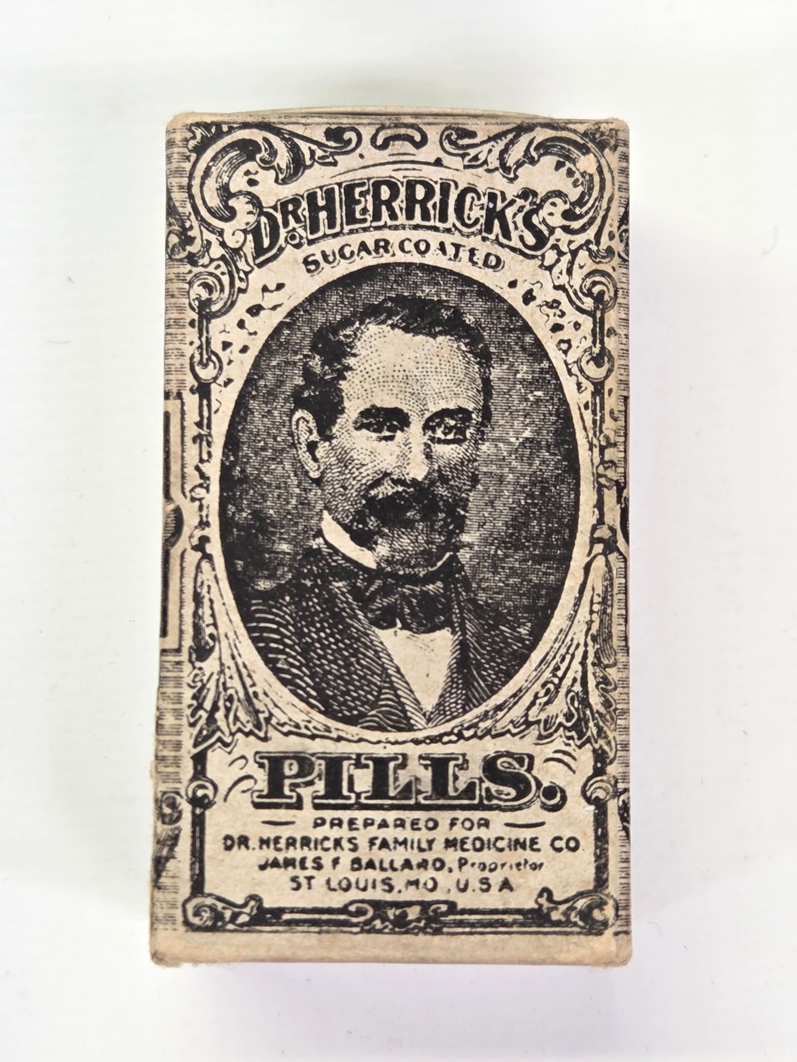 EARLY DR. HERRICK'S SUGAR COATED PILLS BOX: EMPTY BOX REMAINS IN GOOD CONDITION, SHOWING SOME TYPICAL WEAR.