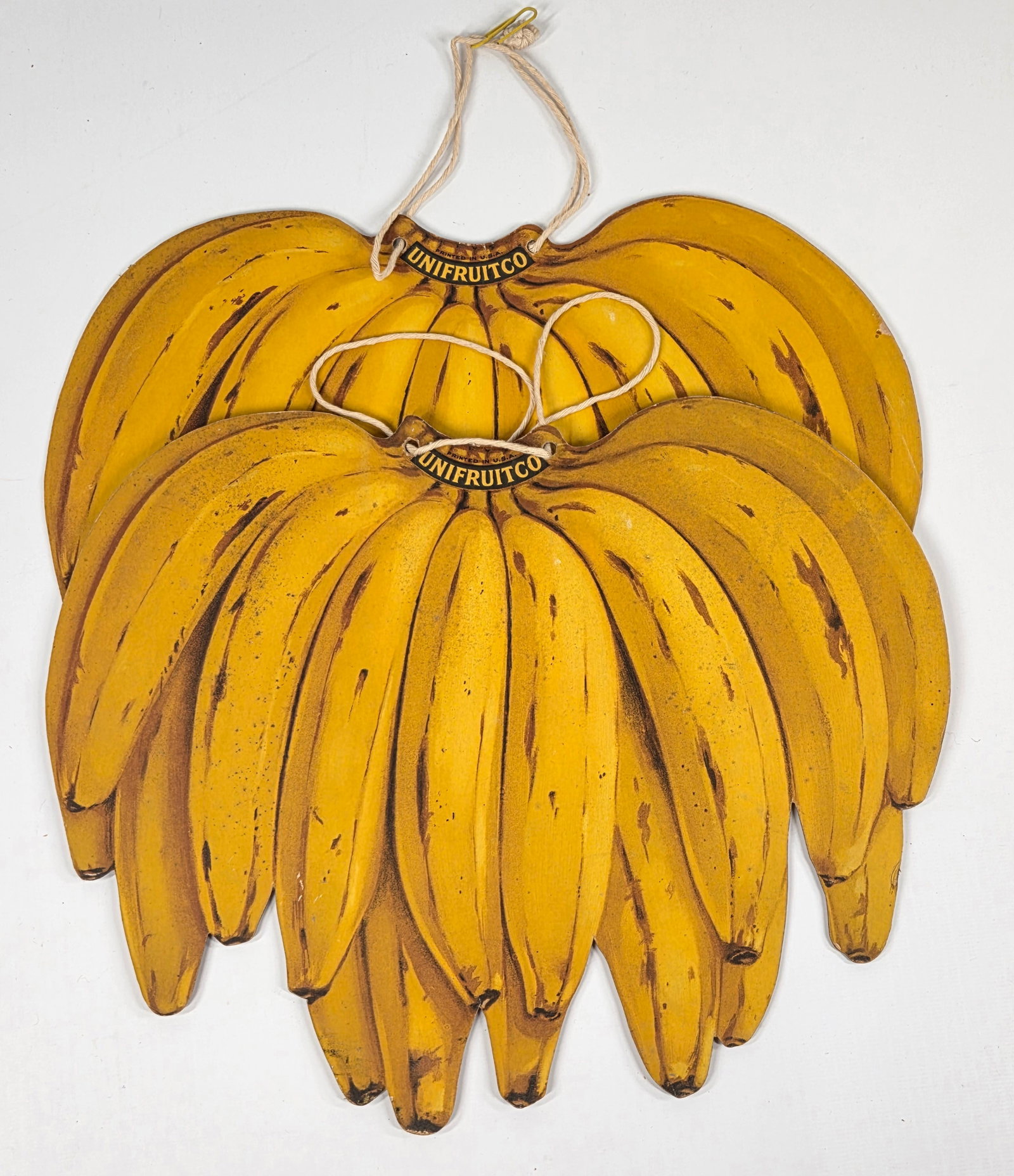 2) UNIFRUITCO CARDBOARD BANANA HANGING SIGNS: BOTH REMAIN IN GOOD CONDITION. ONE WITH CREASE ALONG BOTTOM.