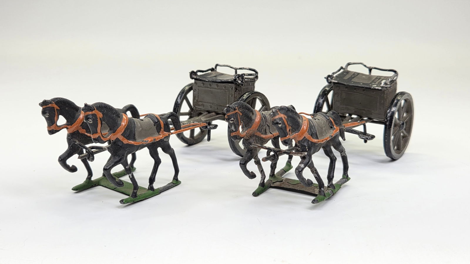 PAIR OF UNMARKED LEAD HORSE LIMBER WAGONS: BOTH REMAIN IN FAIR TO GOOD CONDITION, SHOWING SOME TYPICAL PAINT WEAR.