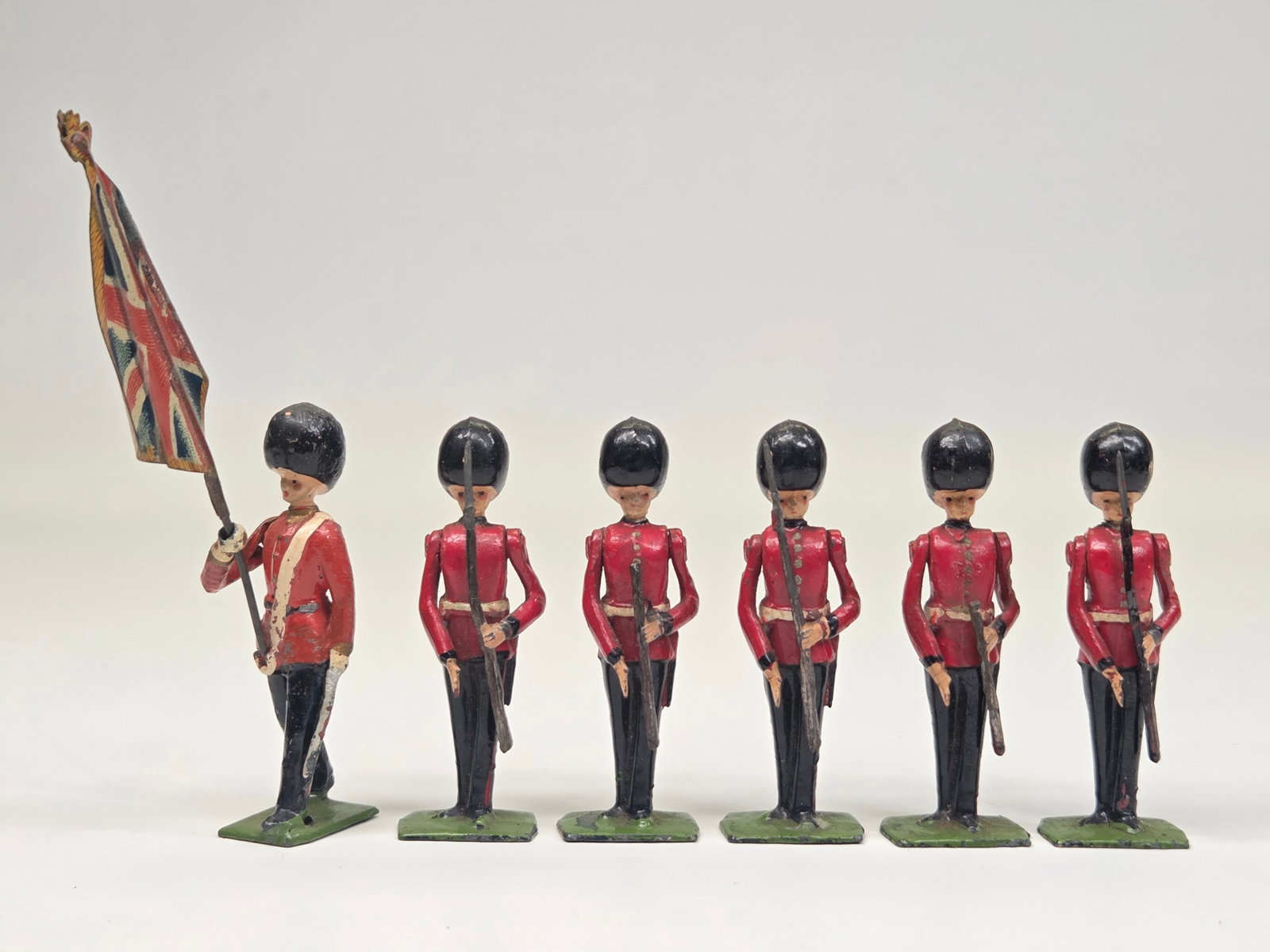 SET OF 6 VINTAGE BRITAINS LEAD SOLDIERS GUARDS: ALL REMAIN IN GOOD CONDITION, SHOWING SOME TYPICAL WEAR. TWO WITH TIPS OF RIFLE BROKEN OFF.