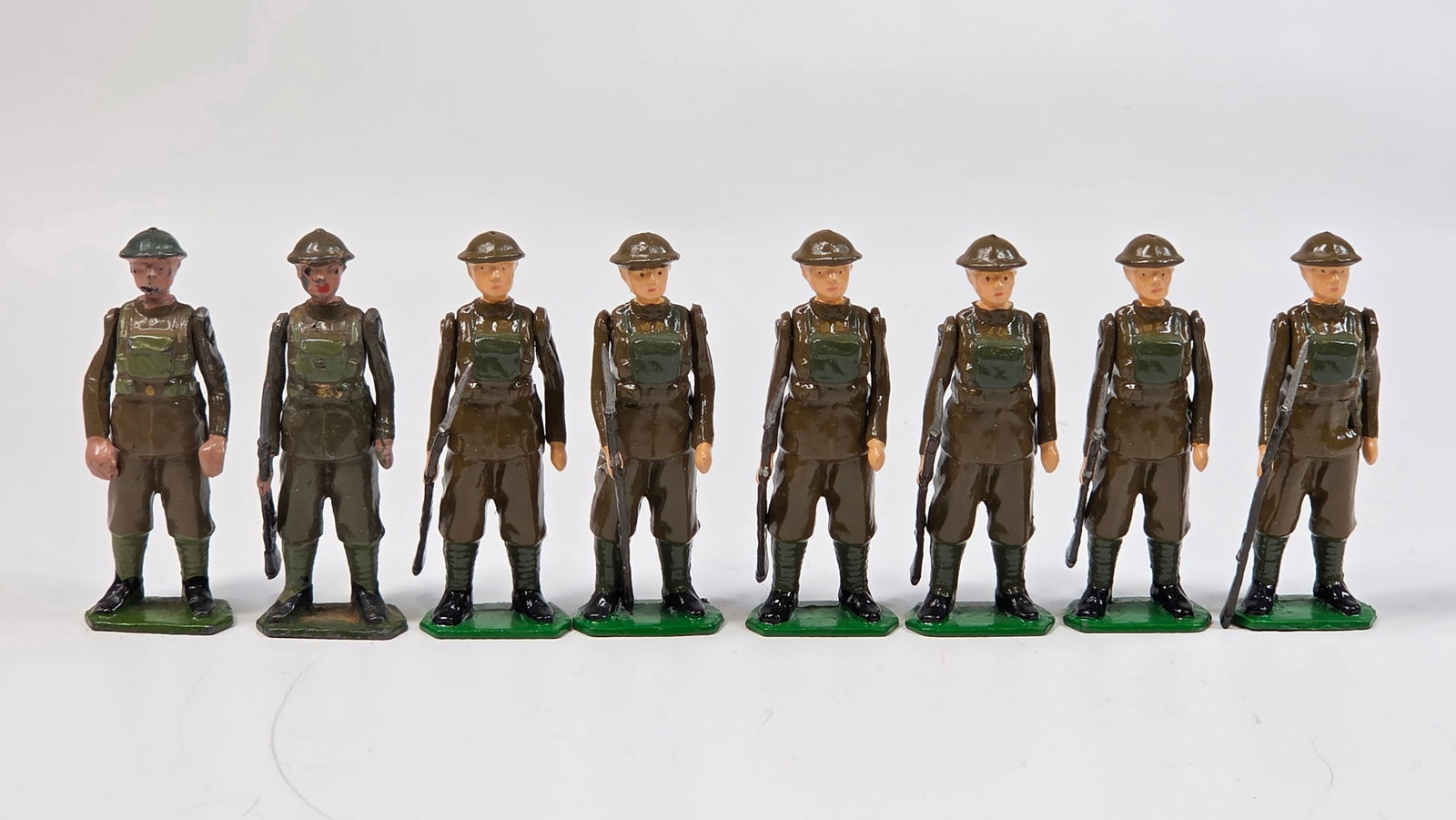 SET OF 8 BRITAIN LEAD SOLDIERS: 6 HAVE BEEN COMPLETELY REPAINTED. 2 ORIGINAL SHOWING WEAR.