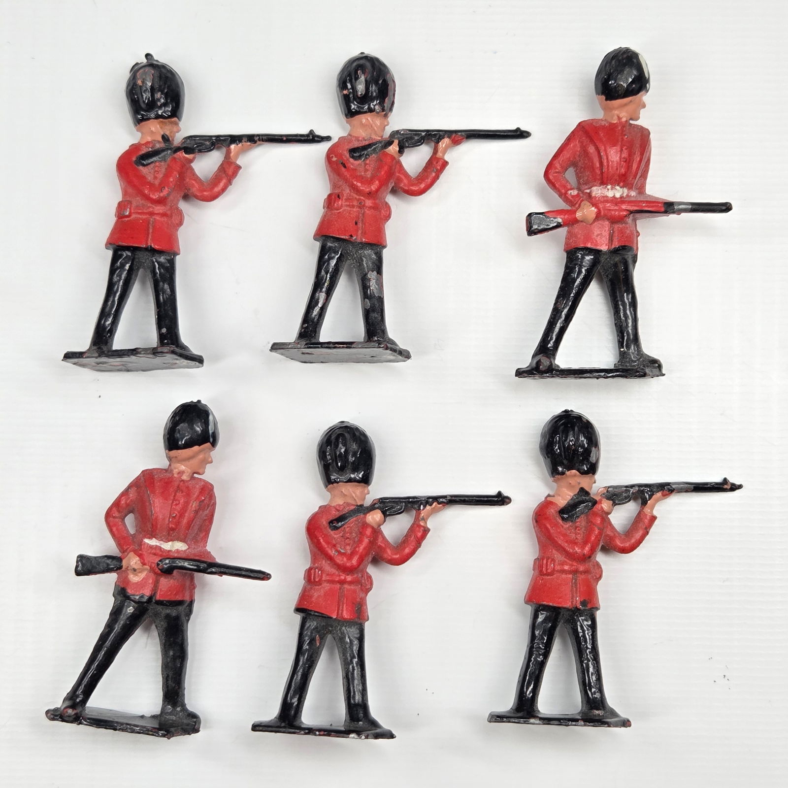 SET OF 6 BRITAINS BRITISH ROYAL GUARDS STANDING FIRING: ALL REMAIN IN FAIR TO GOOD CONDITION, SHOWING SOME TYPICAL PAINT WEAR.