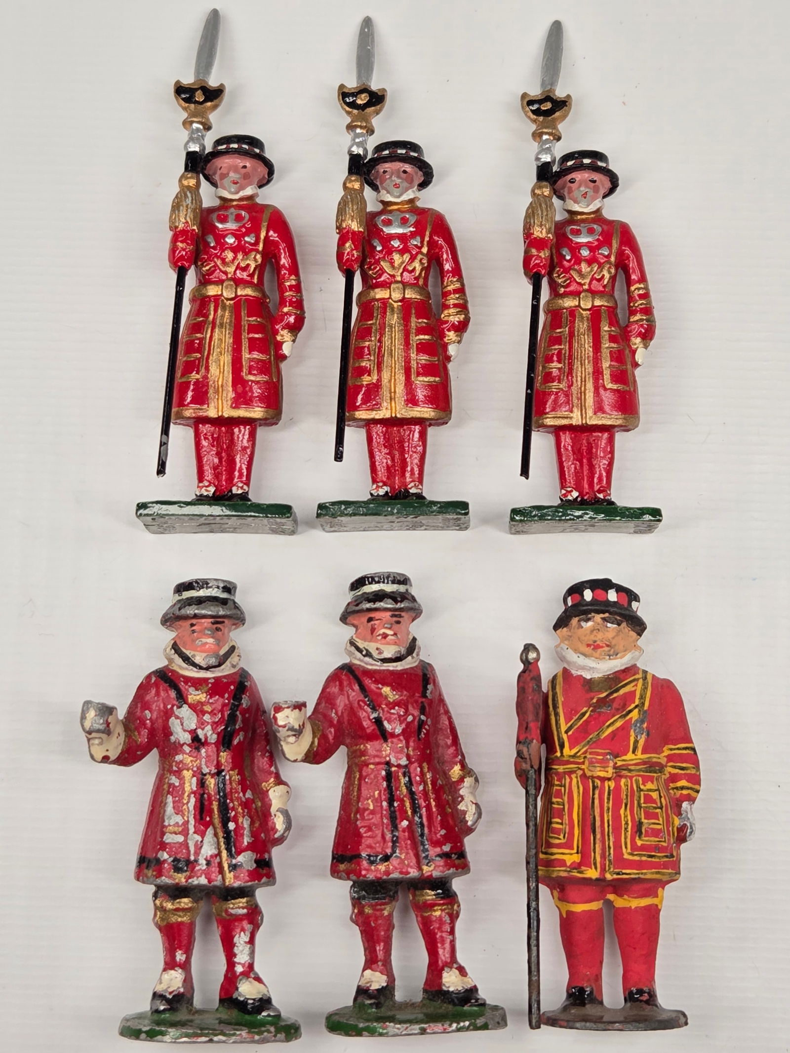 3) BLENHEIM GUARDS & 3) LEAD GUARDS: 3 BLENHEIM PICTURED AT THE TOP REMAIN IN GOOD CONDITION. THE REMAINING SOLDIERS SHOW PAINT WEAR AND MISSING PIECES.