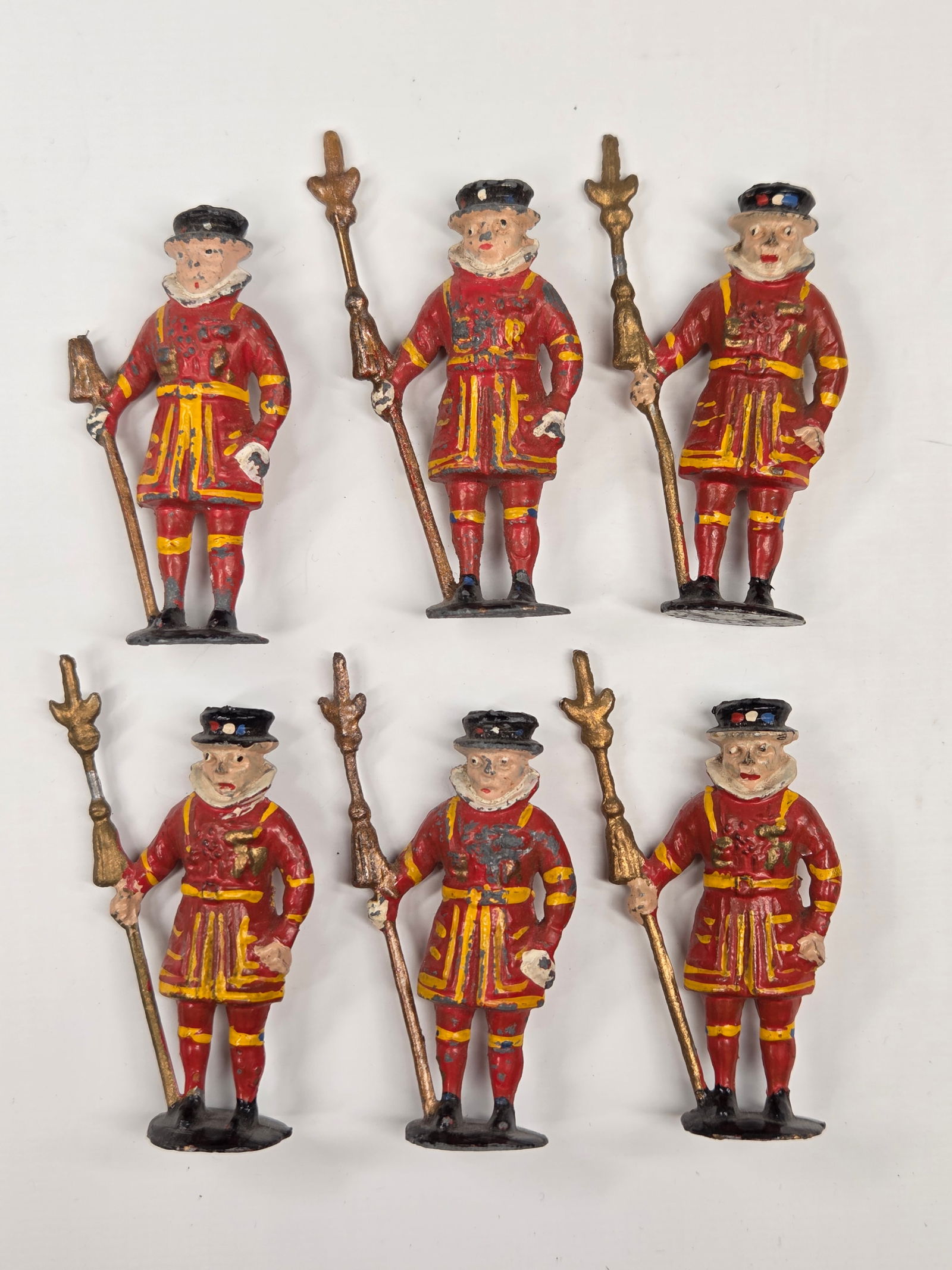 SET OF 6 UNMARKED LEAD BEEFEATER FIGURES: ALL REMAIN IN FAIR TO GOOD CONDITION, SHOWING SOME PAINT WEAR. ONE WITH BROKEN STAFF TIP.