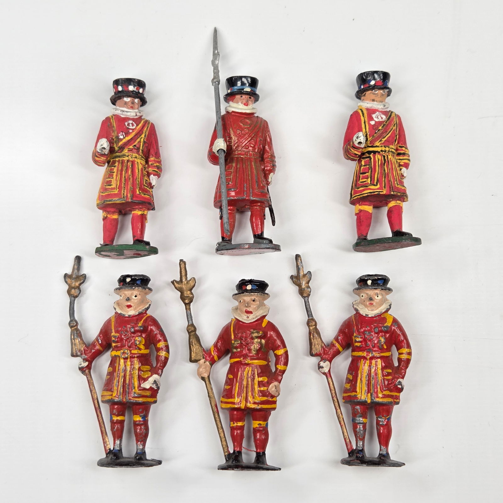 6) VINTAGE UNMARKED LEAD BEEFEATER FIGURES: ALL REMAIN IN FAIR TO GOOD CONDITION, SHOWING SOME TYPICAL WEAR. TWO MISSING STAFFS.
