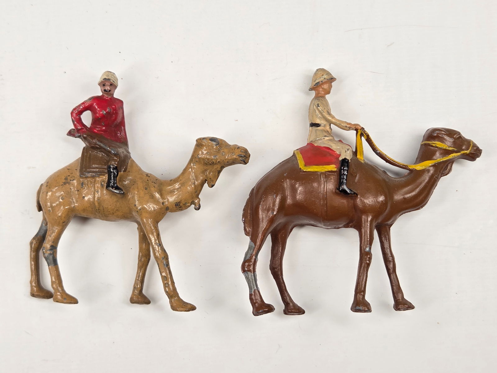 2) VINTAGE LEAD MOUNTED CAMELS: BOTH REMAIN IN GOOD CONDITION, SHOWING SOME TYPICAL PAINT WEAR.