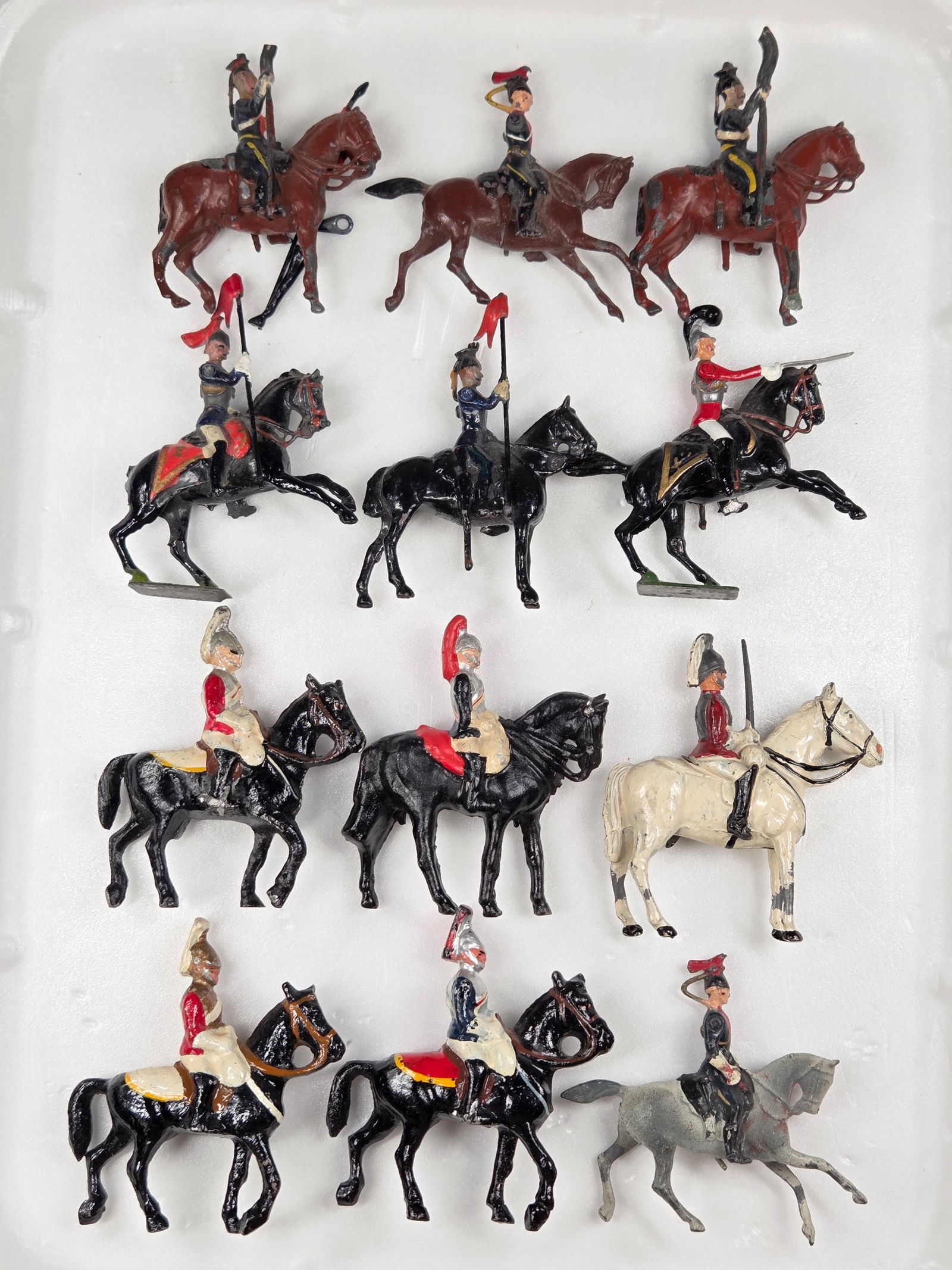 12) VARIOUS VINTAGE BRITAINS MOUNTED SOLDIERS: ALL REMAIN IN FAIR TO GOOD CONDITION, SHOWING TYPICAL PAINT WEAR.ONE SOLDIER WITH MISSING ARM.